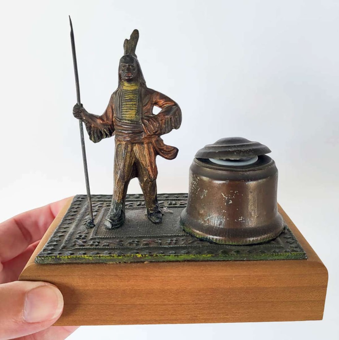 antique bronze Native American inkwell: antique Victorian Era cold painted bronze Native American Indian figure standing on a Persian carpet and holding a long pole and with lidded inkwell next to him (removable insert), possibly sign