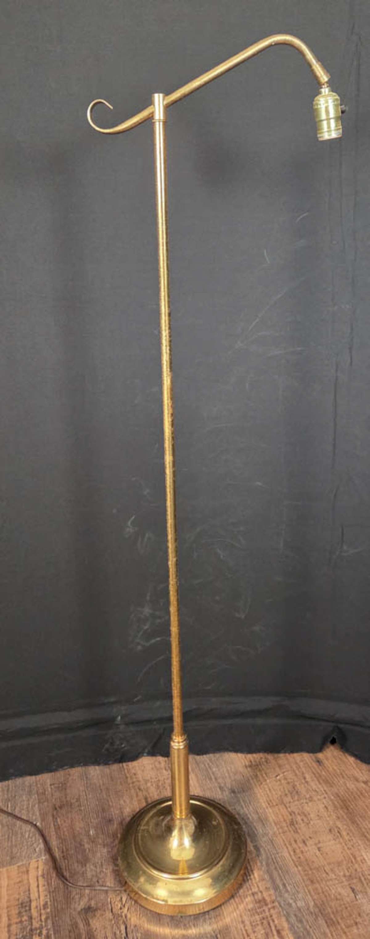 vintage MCM brass floor lamp: unmarked Mid Century Modern brass bridge style floor lamp with heavy stepped round base and adjustable socket angle