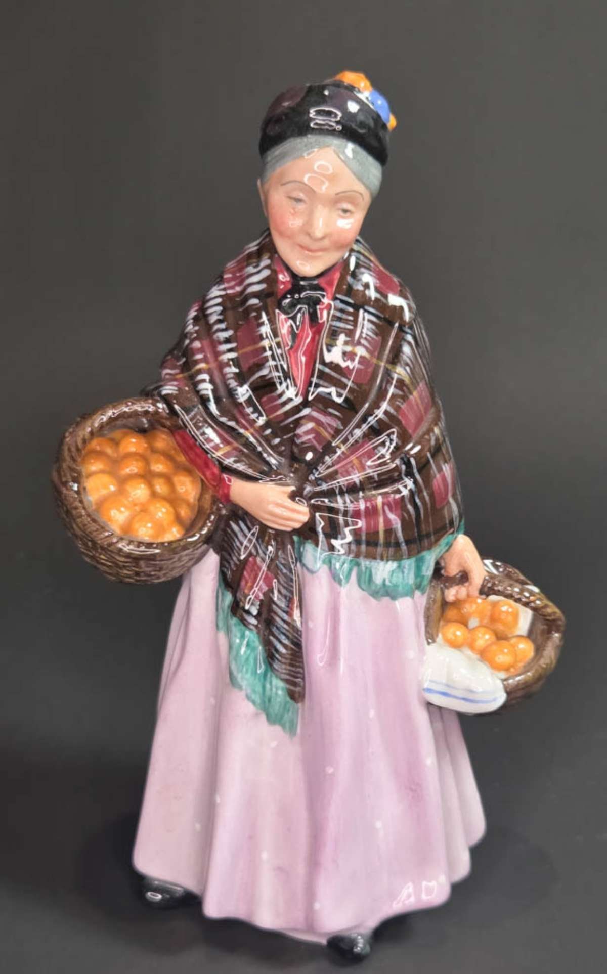 vintage Royal Doulton lady figurine: marked as shown underneath Royal Doulton The Orange Lady BM H.N. 1759, depicting an elderly woman carrying baskets filled with fruit and wearing a shawl around her shoulders