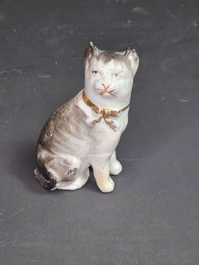 antique Staffordshire animal figurine: miniature antique 1800's figural cat statue, unmarked but most likely English Staffordshire bisque or porcelain with hand painted features and gold ribbon