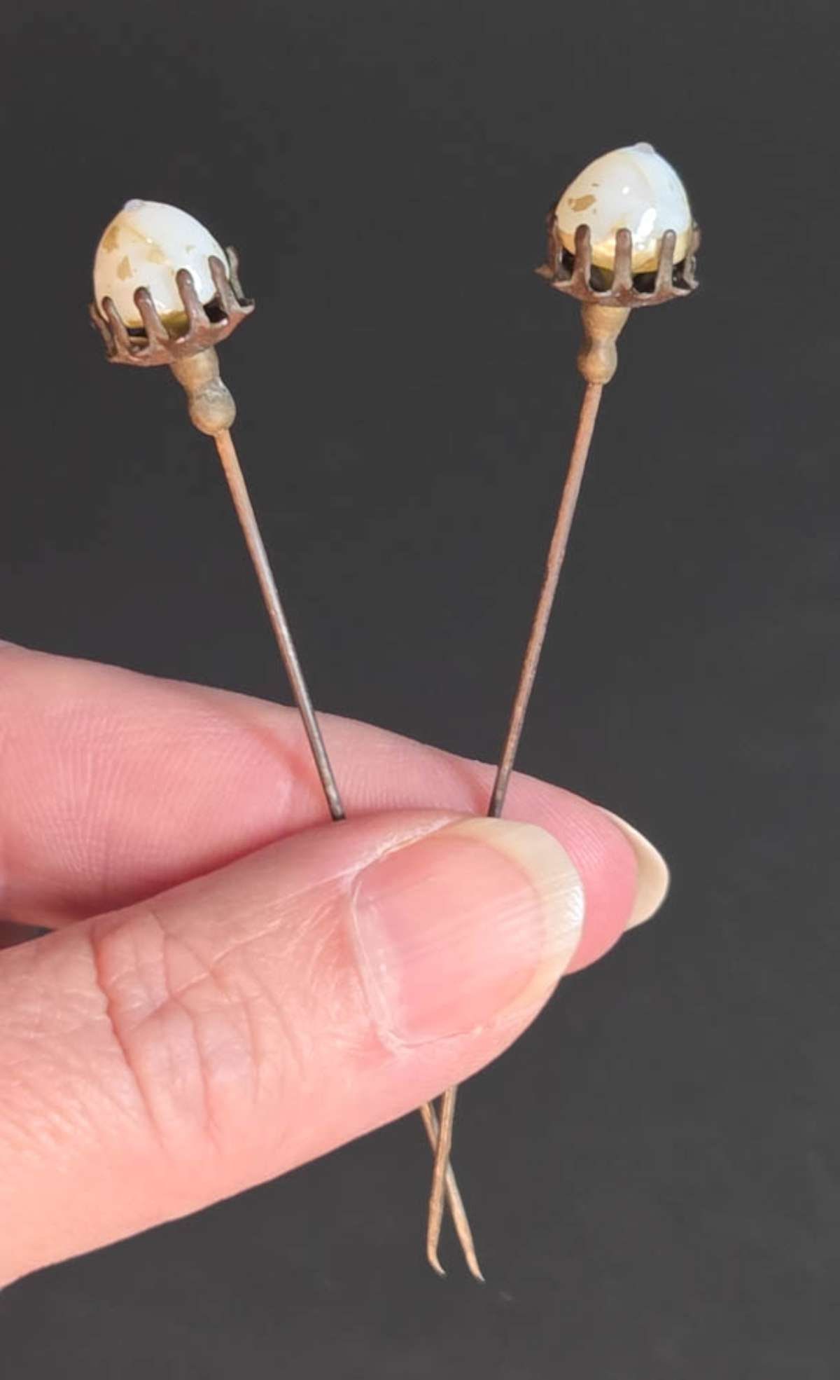 PAIR vintage hat pins: pair of vintage or antique hat pins, metal with inset stone or glass bead with paint remnants aprox. 3 1/8" long each