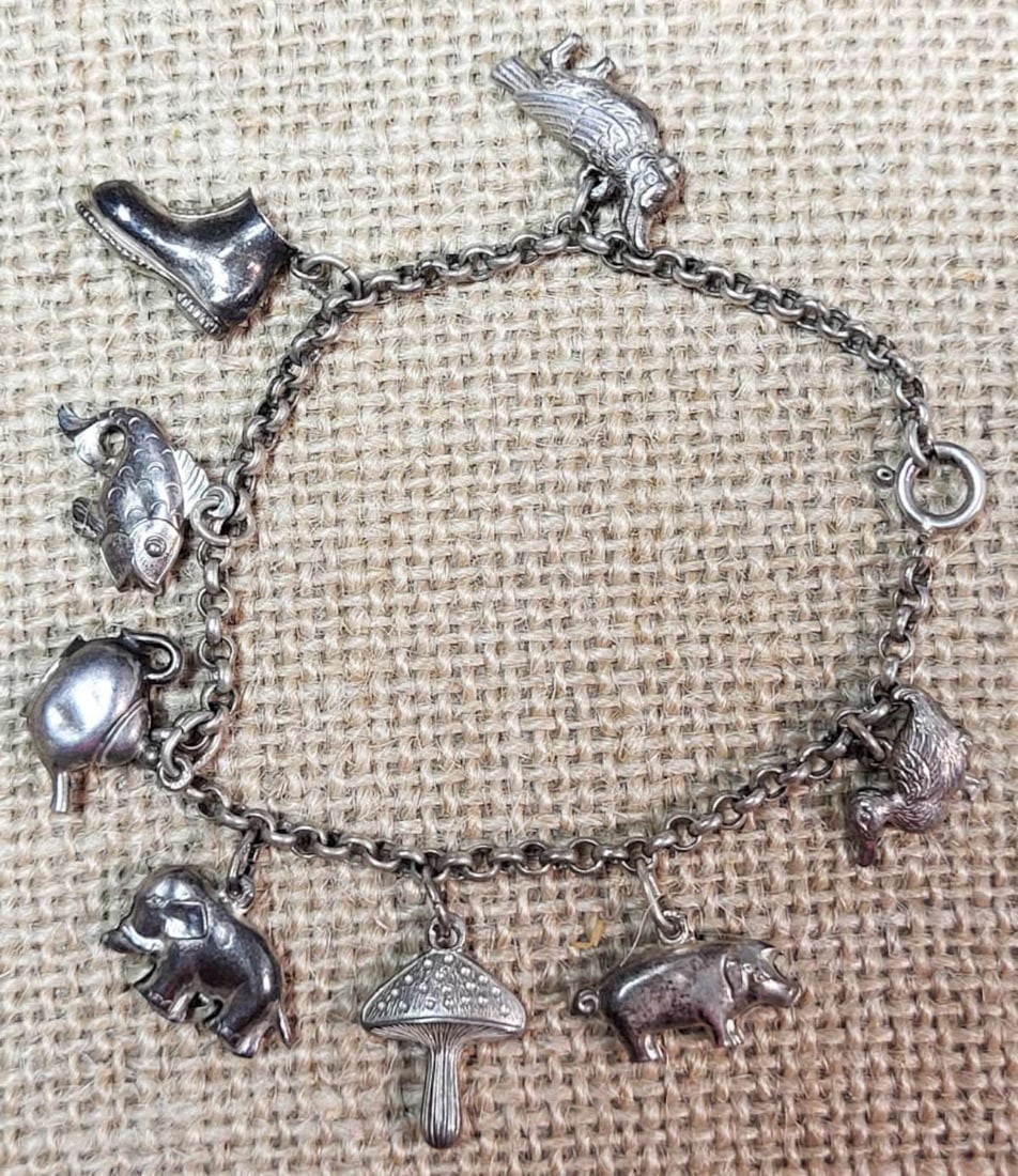 vintage estate jewelry: silver animal charm bracelet: ca. 1950's Dutch (from Holland or The Netherlands) unmarked silver bracelet with 8 charms including birds, pig, mushroom, elephant, fish, teapot and shoe