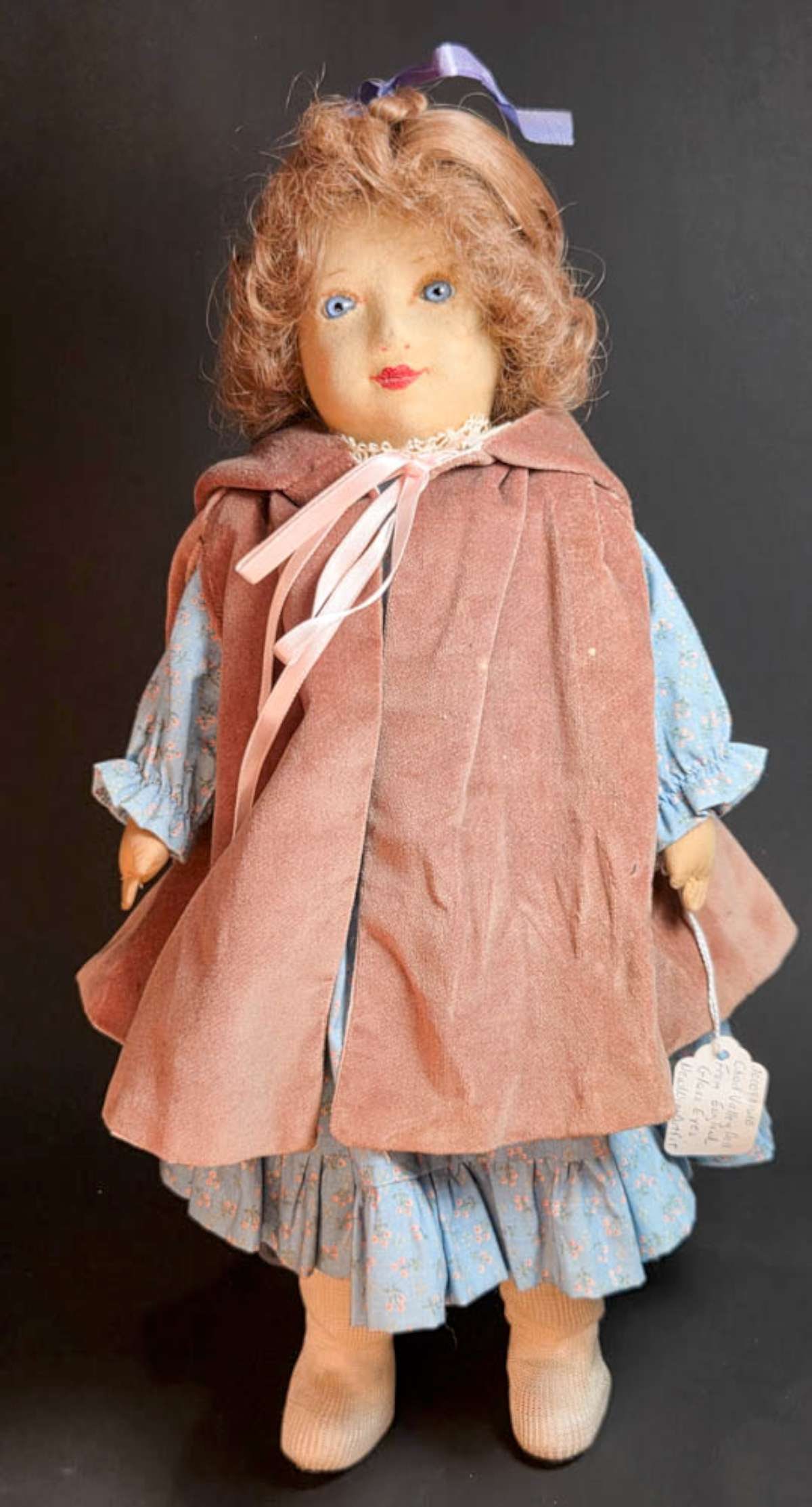 vintage Chad Valley cloth portrait doll: paper label suggests this is a 1930's Chad Valley doll, with vintage blue dress and dusty pink overcoat, vibrant blue eyes and curly brown hair aprox. 16 1/2" tall overall Info f