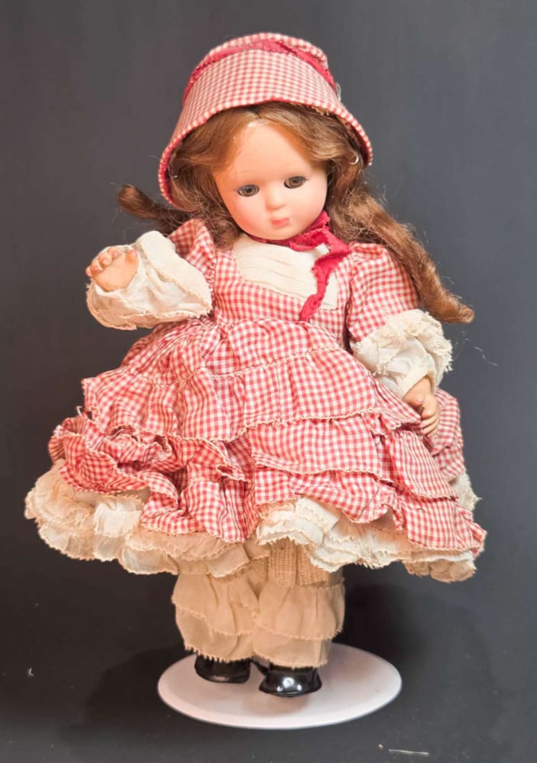 vintage crier girl doll: vintage doll in petticoat and red and cream blocked dress and matching hat, brown hair and brown sleepy eyes, crying mechanism (non working) aprox. 11" tall overall