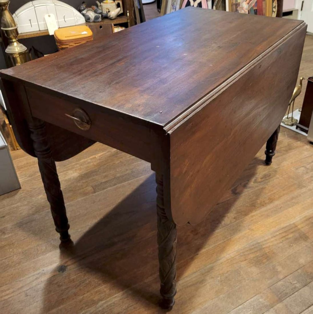 antique carved wooden dining table with leaves: antique mahogany stained wooden dining room table with two drop-down (or flip-up) leaves and two fake drawers with pulls, sturdy carved legs complete the look, ca. 1880 39" long by 22