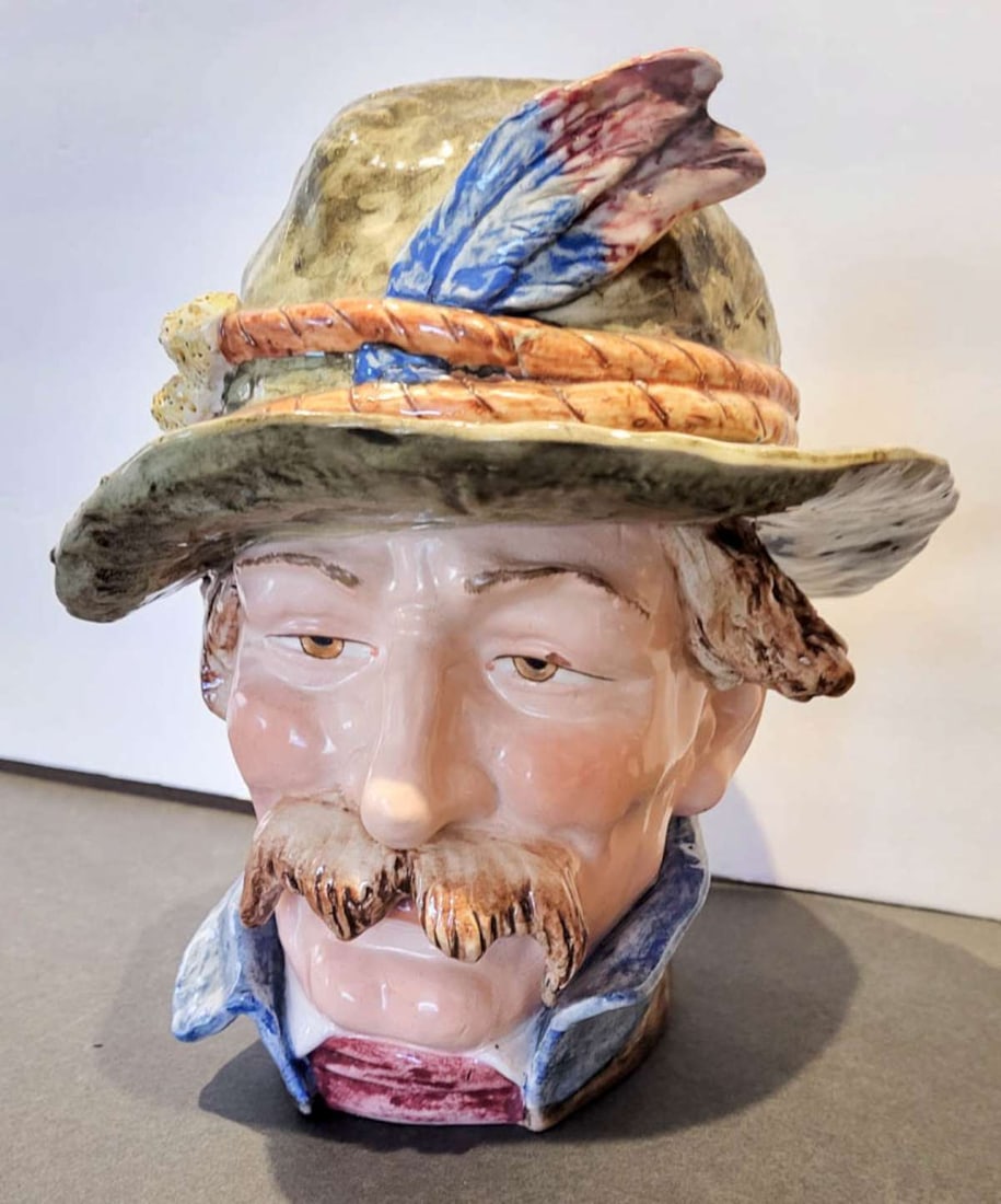 antique pottery figural tobacco lidded jar: antique figural porcelain or Majolica chew or tobacco pot or humidor with lid, shaped like a man with a handlebar moustache and feathered Tylorean hat and marked underneath as shown with