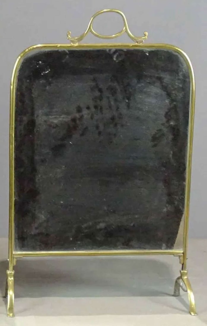 antique Victorian fireplace screen mirror: antique brass framed and footed firescreen with mirror and carrying handle on top