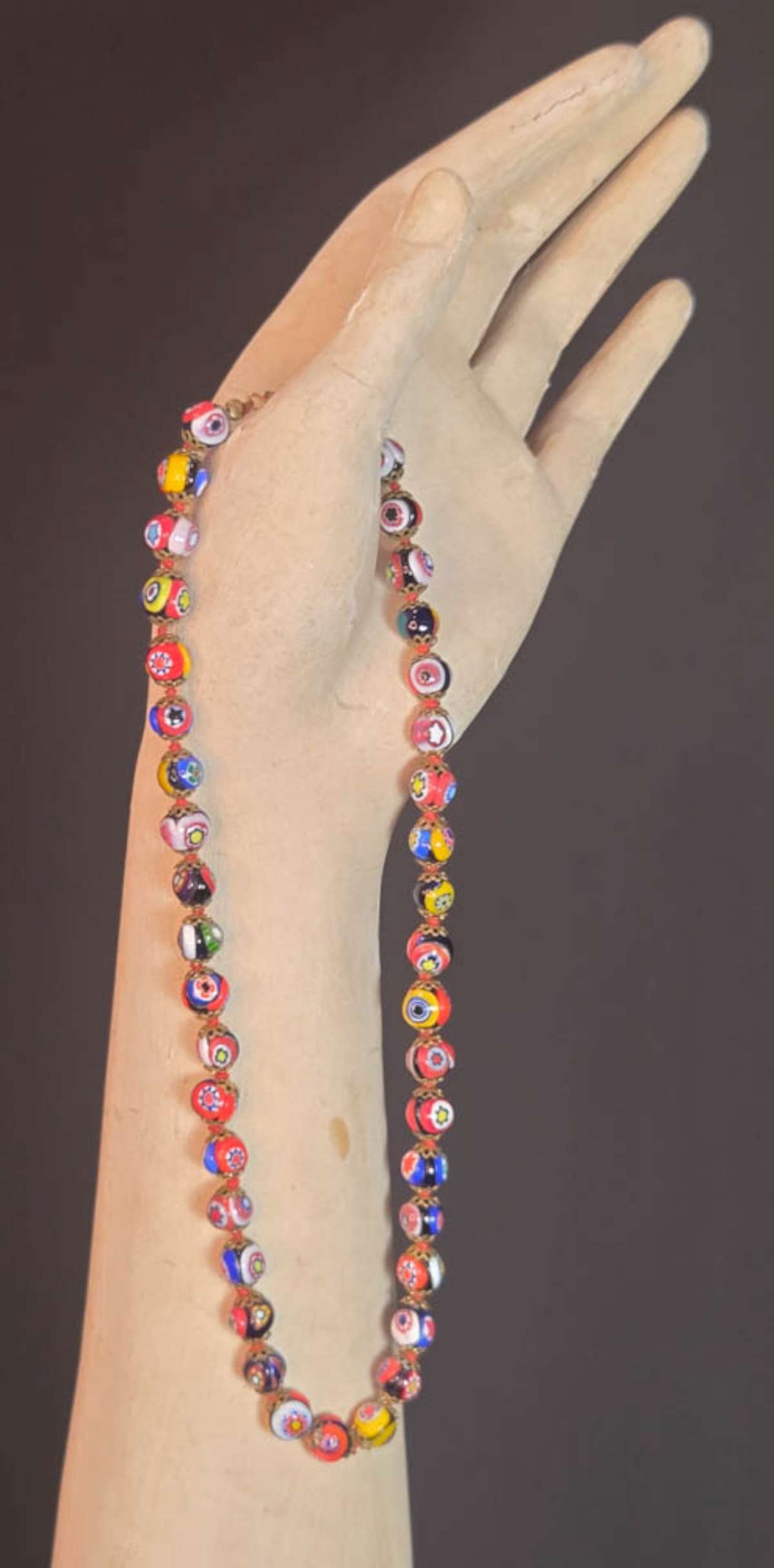vintage estate jewelry: Murano millefiori necklace: vintage Venetian (Murano?) necklace with millefiori glass round beads with floral or flower design and brass end caps and twist closure aprox. 16" long