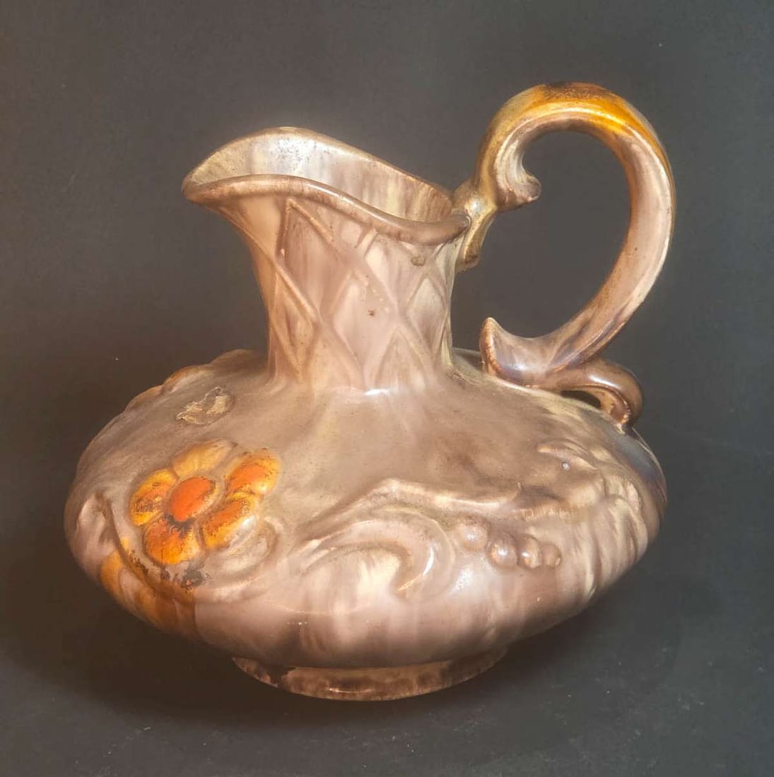 vintage MCM handled floral pitcher: Mid Century Modern or MCM porcelain or pottery handled pitcher, marked 545 Germany underneath, with earth tone drip glaze and floral or flower design almost 6" tall overall by widest 