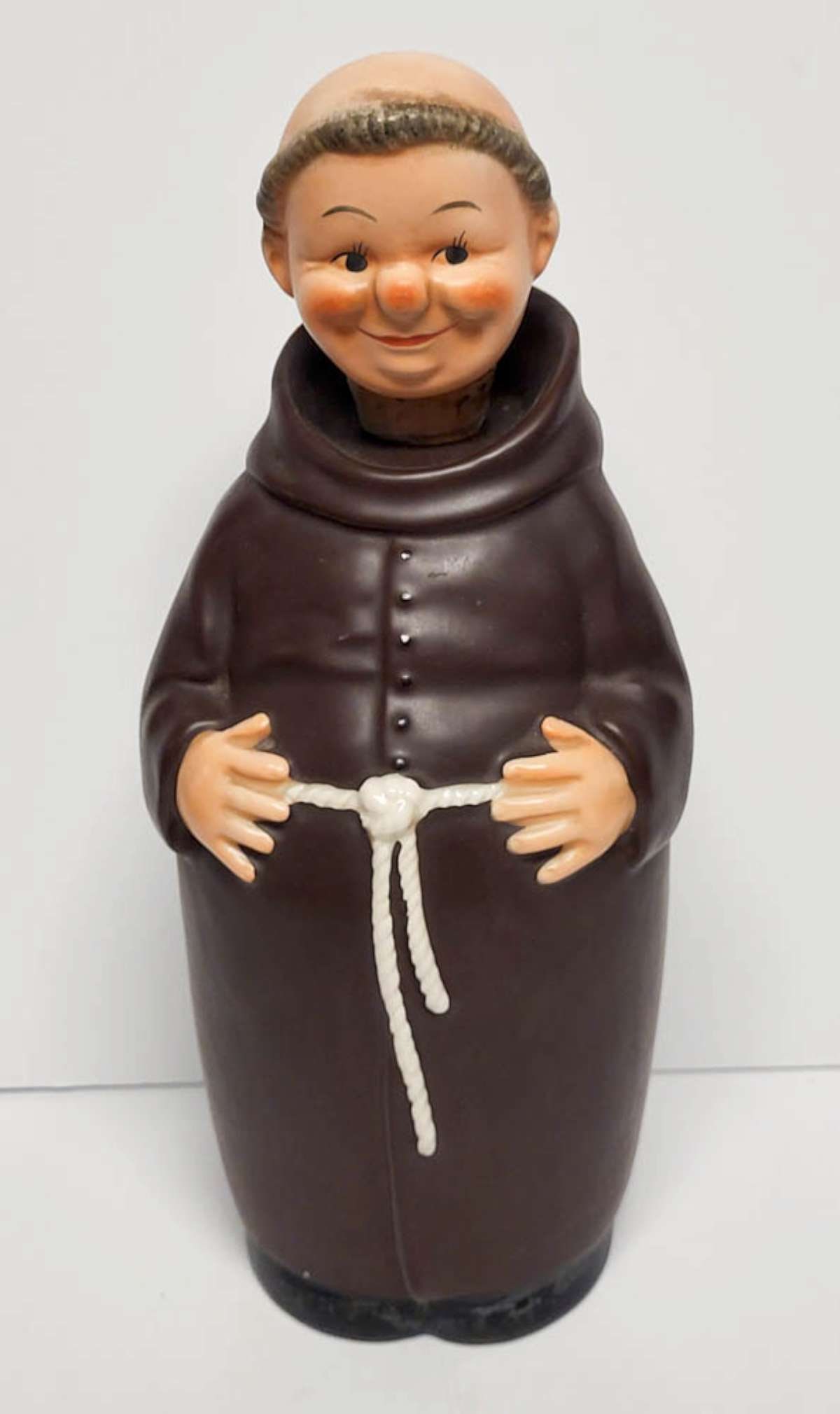 antique Goebel monk liquor bottle: vintage or antique decanter or liquor bottle made of porcelain and with the head being the stopper, depicting a Friar Tuck monk in habit and marked underneath as shown bee in V West Germany and 