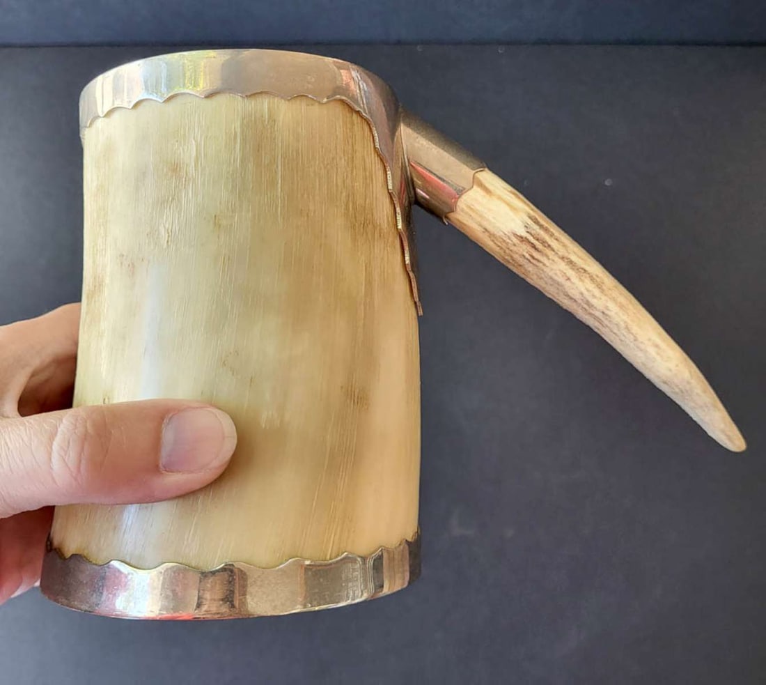 antique horn stein with antler handle: antique carved horn tankard with with scalloped edge silver plated metal rims and antler handle 3 7/8" diameter bottom, is 5" tall and about 7" wide to the end of the handle