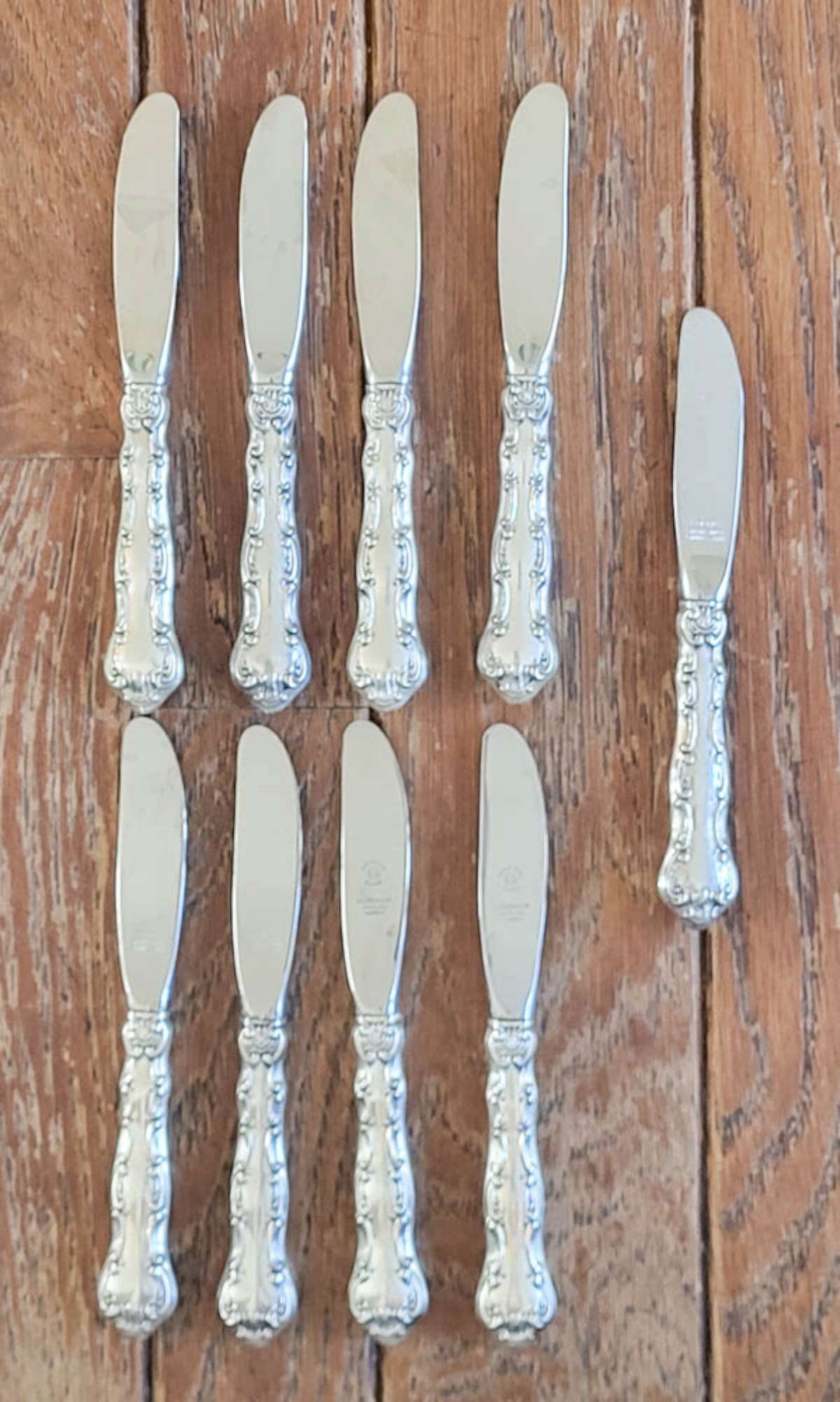 Sterling silver Gorham flatware - knives: antique set of 9 marked Sterling Gorham short (butter?) knives or spreaders with elaborate handles and stainless steel blades total weight is 398 grams Info from online search: "Flowing