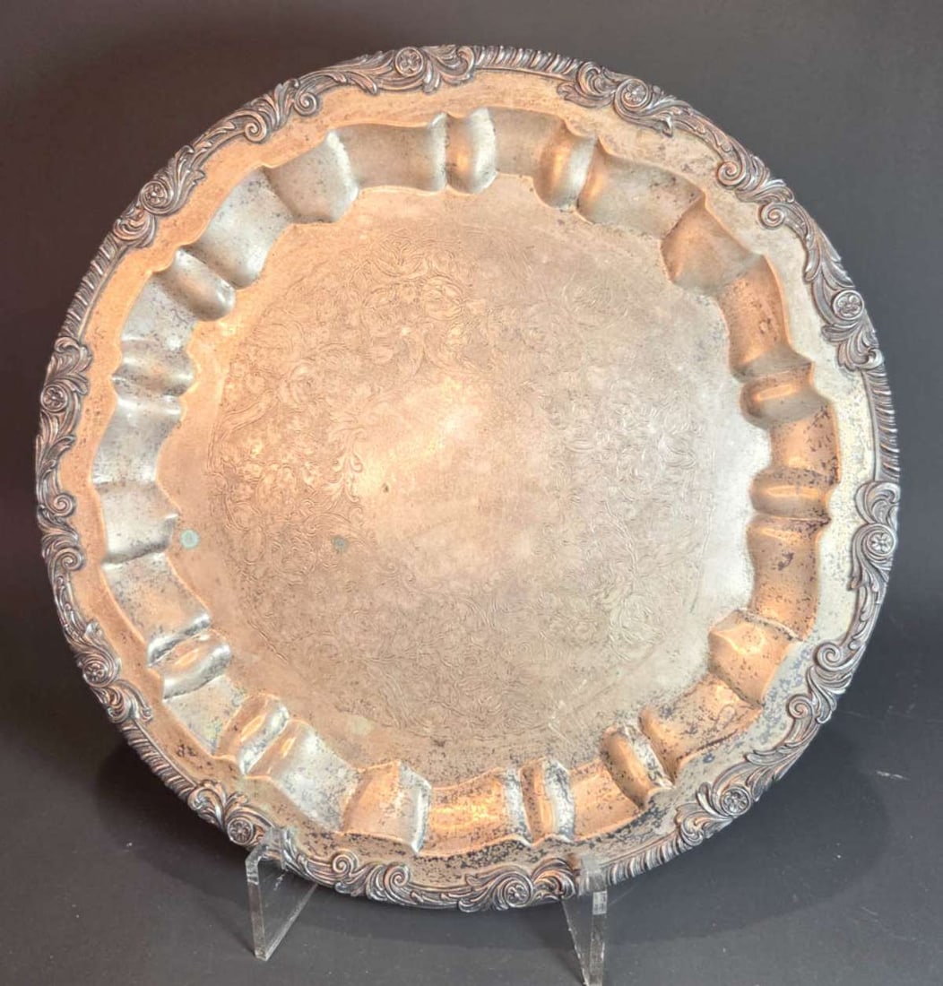 antique silver (plated?) footed platter: circular serving platter or raised tray on scroll feet, abstract floral and leaf edge with engraved center and illegible hallmarks as shown underneath - NOTE: yellow tint in first picture is