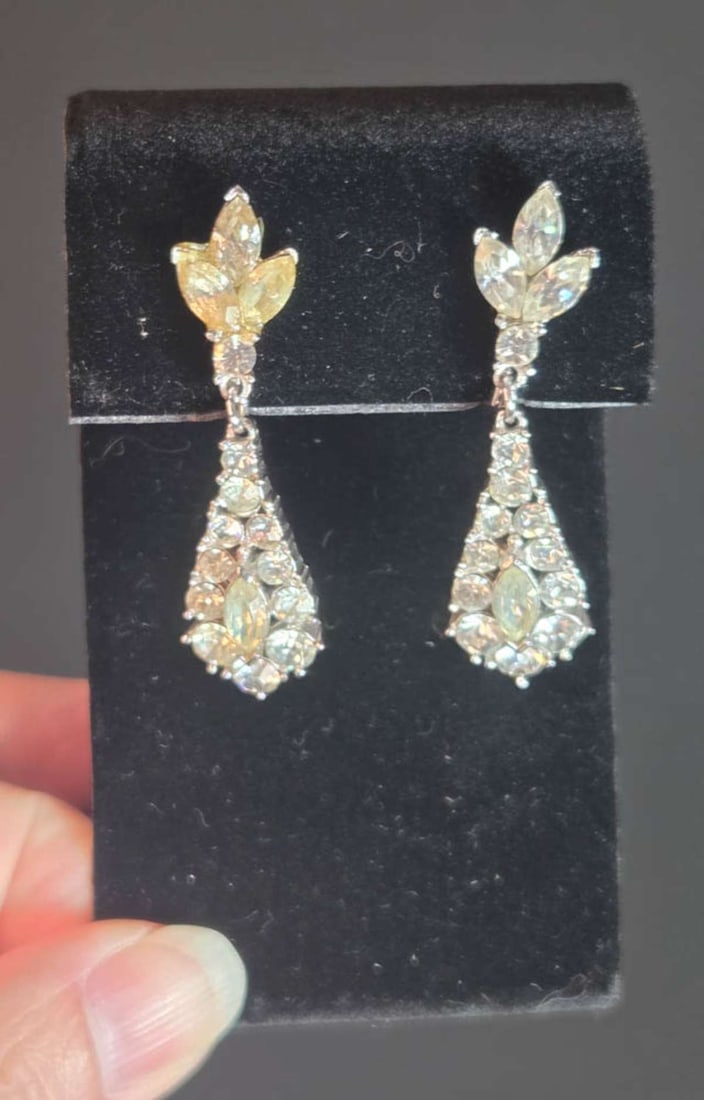 vintage estate jewelry: Trifari earrings: vintage screw back pair of earrings, marked Trifari and with dangly teardrop shaped drop and floral or leaf shaped top part, with clear cut rhinestones, paste or diamante