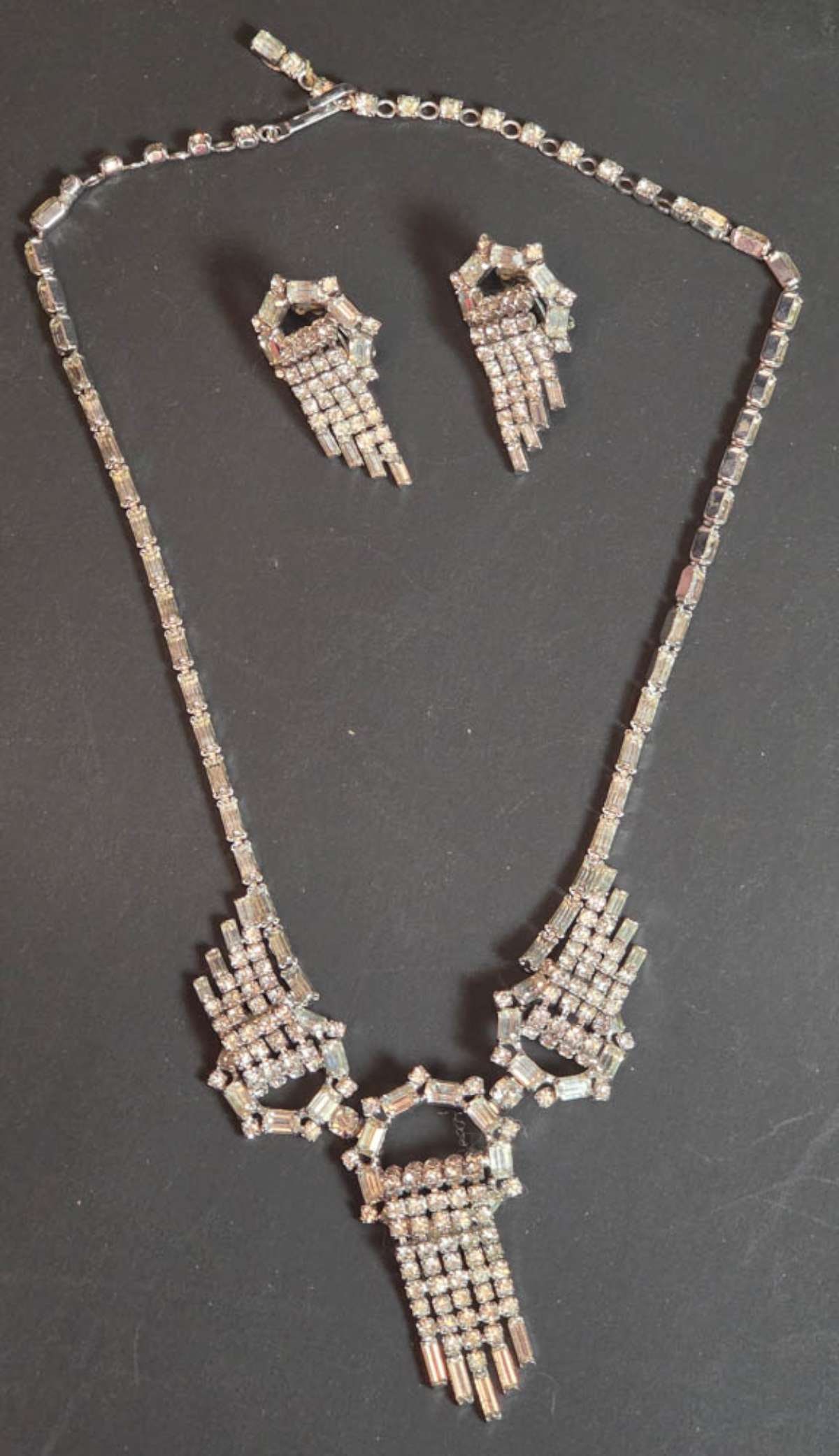 vintage estate jewelry: Kramer of New York suite: vintage MCM or Mid Century Modern marked Kramer of N.Y. suite, consisting of a waterfall dangly fringe designed necklace and matching pair of clip earrings, with clear cut rhinestones&comm