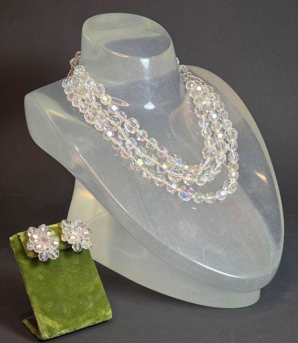 vintage estate jewelry: rhinestone suite: antique or vintage rhinestone jewelry suite, consisting of a pair of unmarked but possibly silver clip earrings and a triple strand necklace, all with iridescent stones from the German Rhe