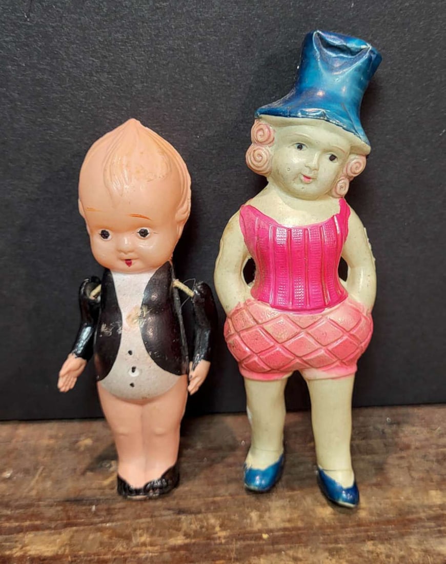 PAIR antique miniature celluloid or plastic dollhouse dolls: set or lot of two early to mid-1900's plastic or celluloid mini dolls, larger marked illegibly and with (plus sign) logo and shaped like a girl with hat and outfit reminiscent of the circus