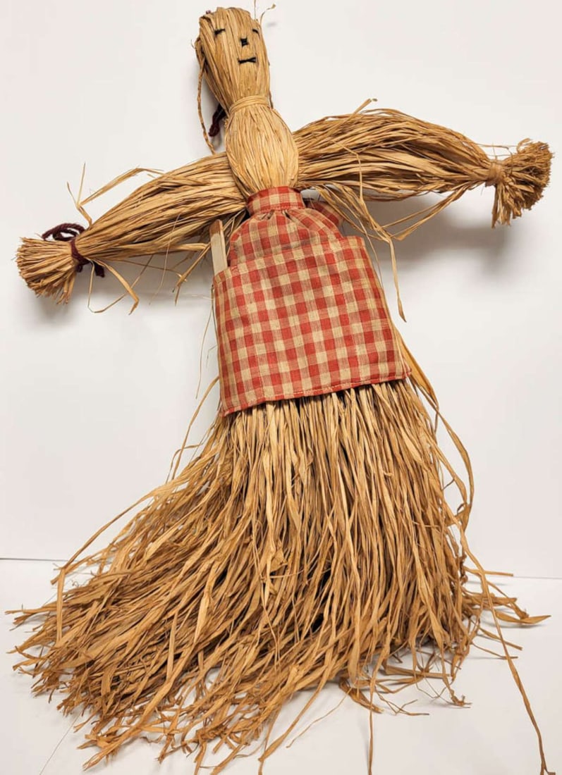 vintage Folk Art straw doll: vintage (or possibly even antique) cornhusk or scarecrow doll, made from dried straw or other plant material and with old red and cream checkered hand sewn or stitched apron and artist's ta