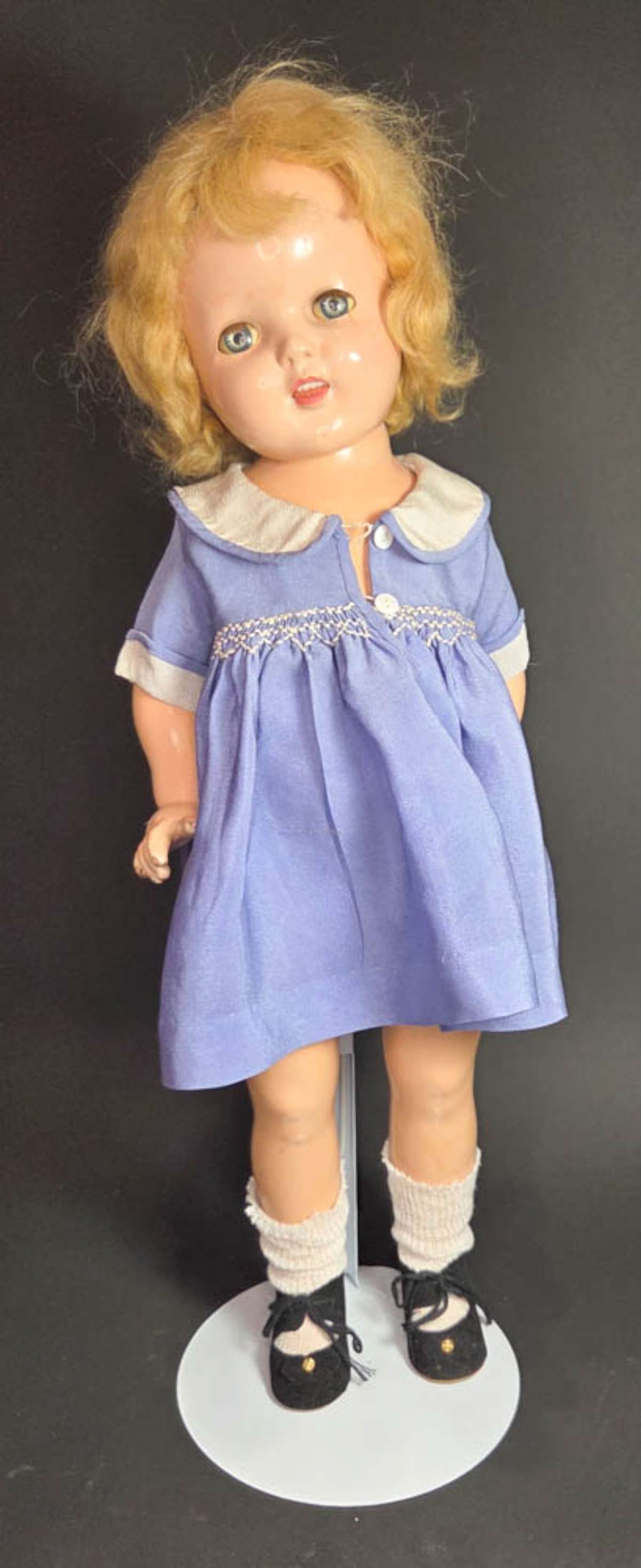 vintage Shirley Temple doll: ca. 1930's Shirley Temple doll with composition head and body with poseable limbs, open mouth with teeth showing, blue and white dress and sleepy eyes