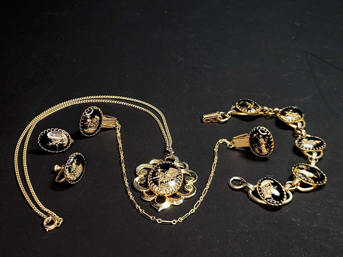 vintage estate jewelry: Asian Intaglio suite: gold toned and black glass (?) accented vintage suite, consisting of a pair of screw back earrings, lapel clips, bracelet and necklace with pendant, all pieces with scenes of w