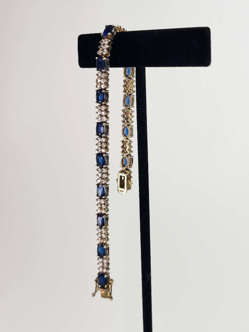 vintage estate jewelry: tennis bracelet: vintage marked 925 for Sterling silver tennis bracelet with blue Sapphire and clear cut rhinestone stones, double closure for safety aprox. 7 1/4" long