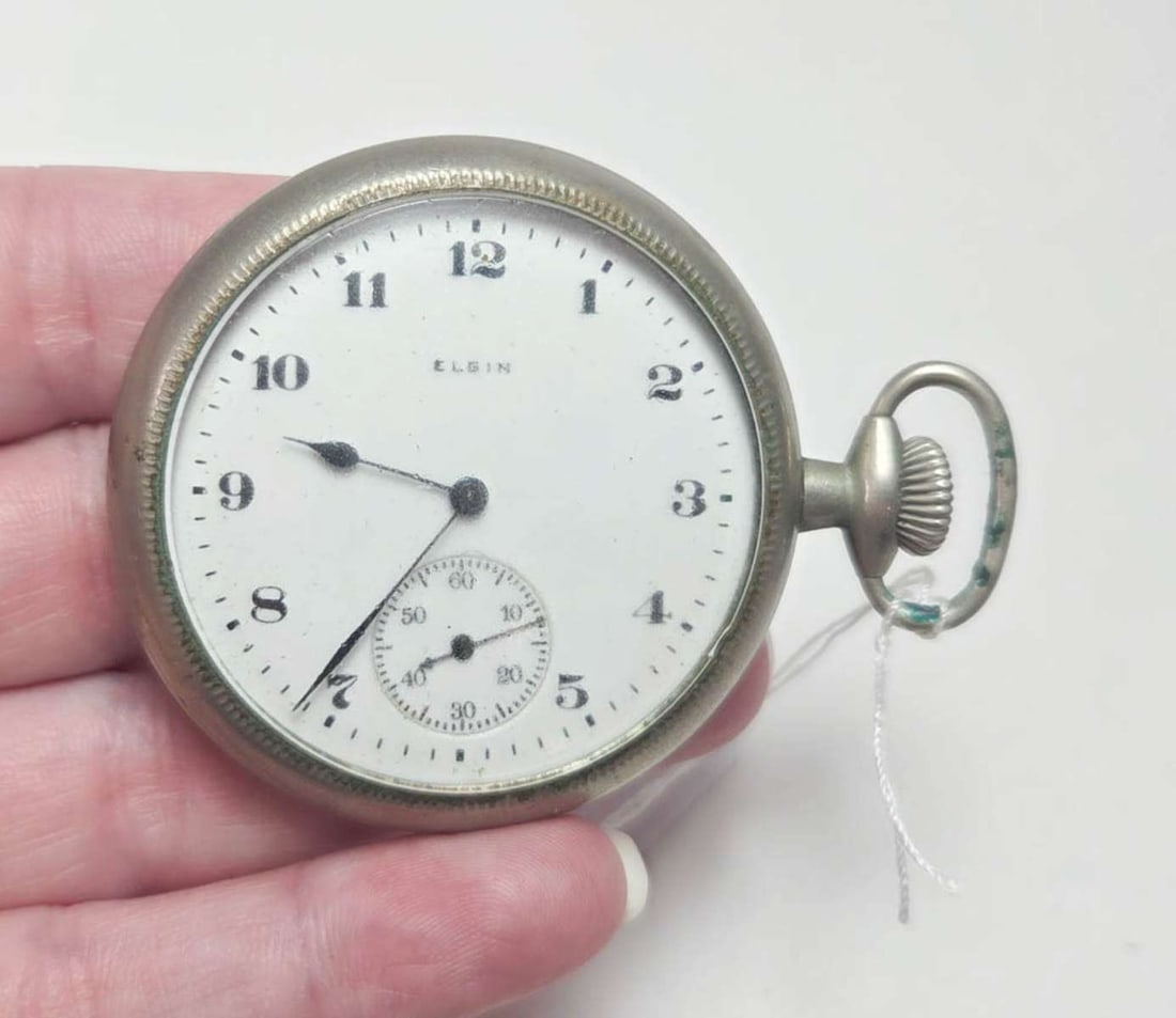 antique Elgin pocket watch: antique nickel or plated open faced pocket watch with white enameled dial and second hand, doesn't run so might need a clean and oil about 1 3/4" in diameter, not including the w