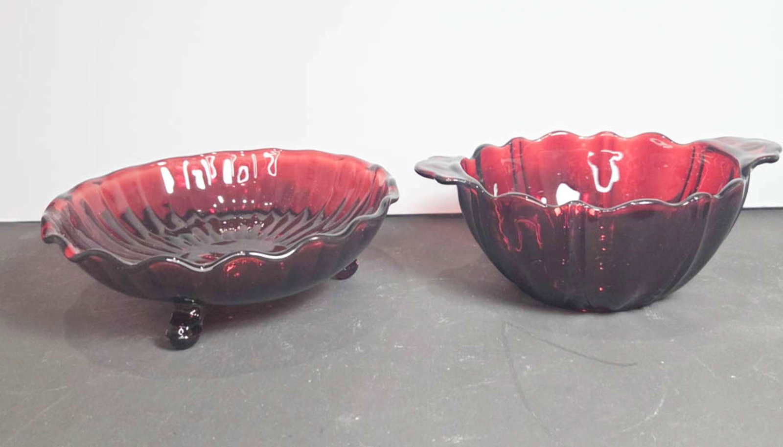 pair MCM Anchor Hocking Royal Red Ruby dishes: unmarked Mid Century Modern set or lot of two scalloped edge dishes, 1 with handles, 1 on feet, in a vibrant red color 6 3/4" in diameter (largest)
