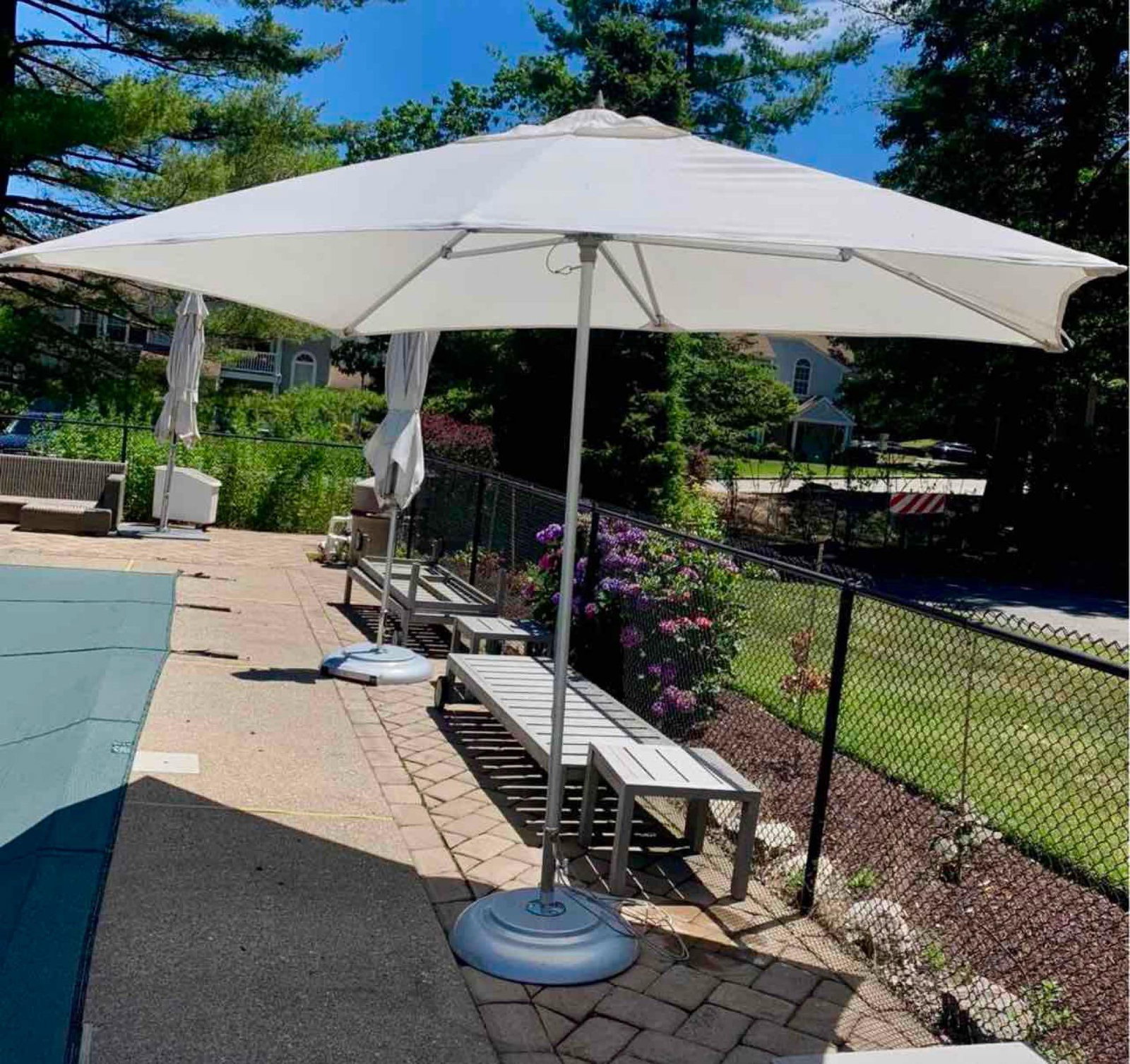 TUUCI Luxury Outdoor Rectangle Umbrella with Rolling Wheel Base, Custom Cover, 8 x 10': Very special true luxury center pole umbrella for discerning homeowners that want to enhance an outdoor oasis. This lot includes the umbrella, custom cover, and TUUCI rolling base with wheels. Brand: 