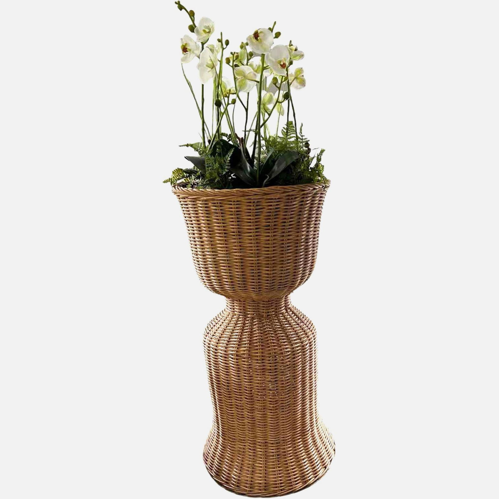 Tall Sculptural Natural Wicker Plant Stand: Tall wicker plant stand. The stand features a sculptural silhouette with a flared base and top, offering a sturdy yet decorative display for potted plants. Material: Wicker Color: Natural unpainted