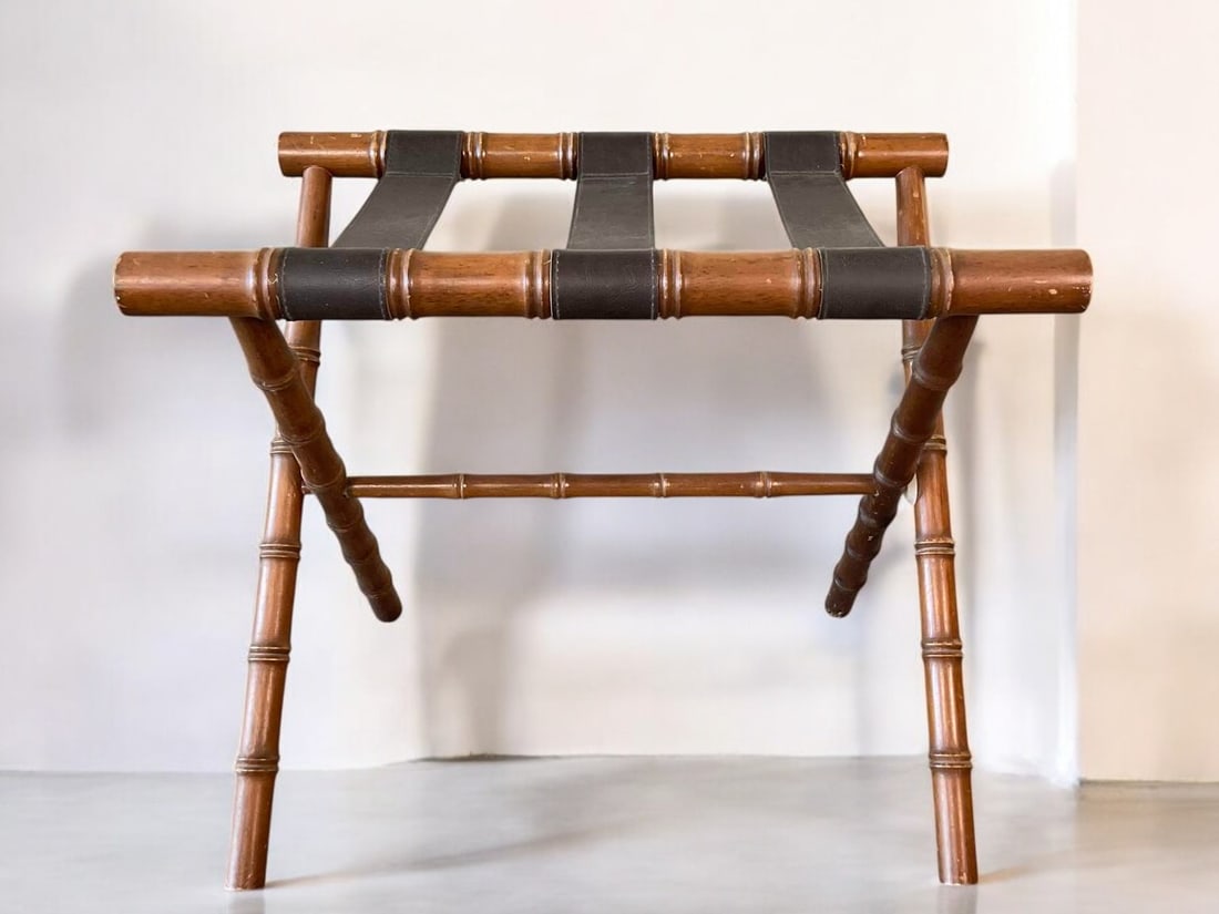Wood and Leather Faux Bamboo Folding Luggage Rack: This vintage folding luggage rack features a dark-stained bamboo-style wood frame with three black leather straps. Its timeless design complements a variety of interiors, including Chinoiserie, coasta