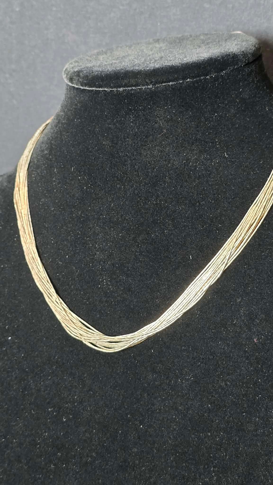 Sterling Silver Multi-Strand Necklace: Elegant sterling silver multi-strand necklace composed of numerous fine silver wire strands gathered into tapered sterling end caps with a spring ring clasp. The layered wire design creates fluid move