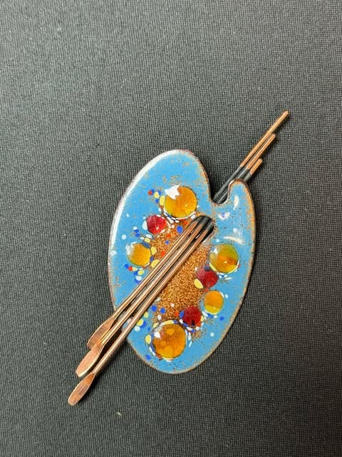 Vintage Matisse & Renior Copper and Blue Enamel Artist Palette Brooch: Vintage copper enamel brooch featuring a vibrant blue ground with abstract enamel accents in red, yellow, and white. Design evokes mid-century modern Matisse-style artistry. Signed on reverse. Elongat