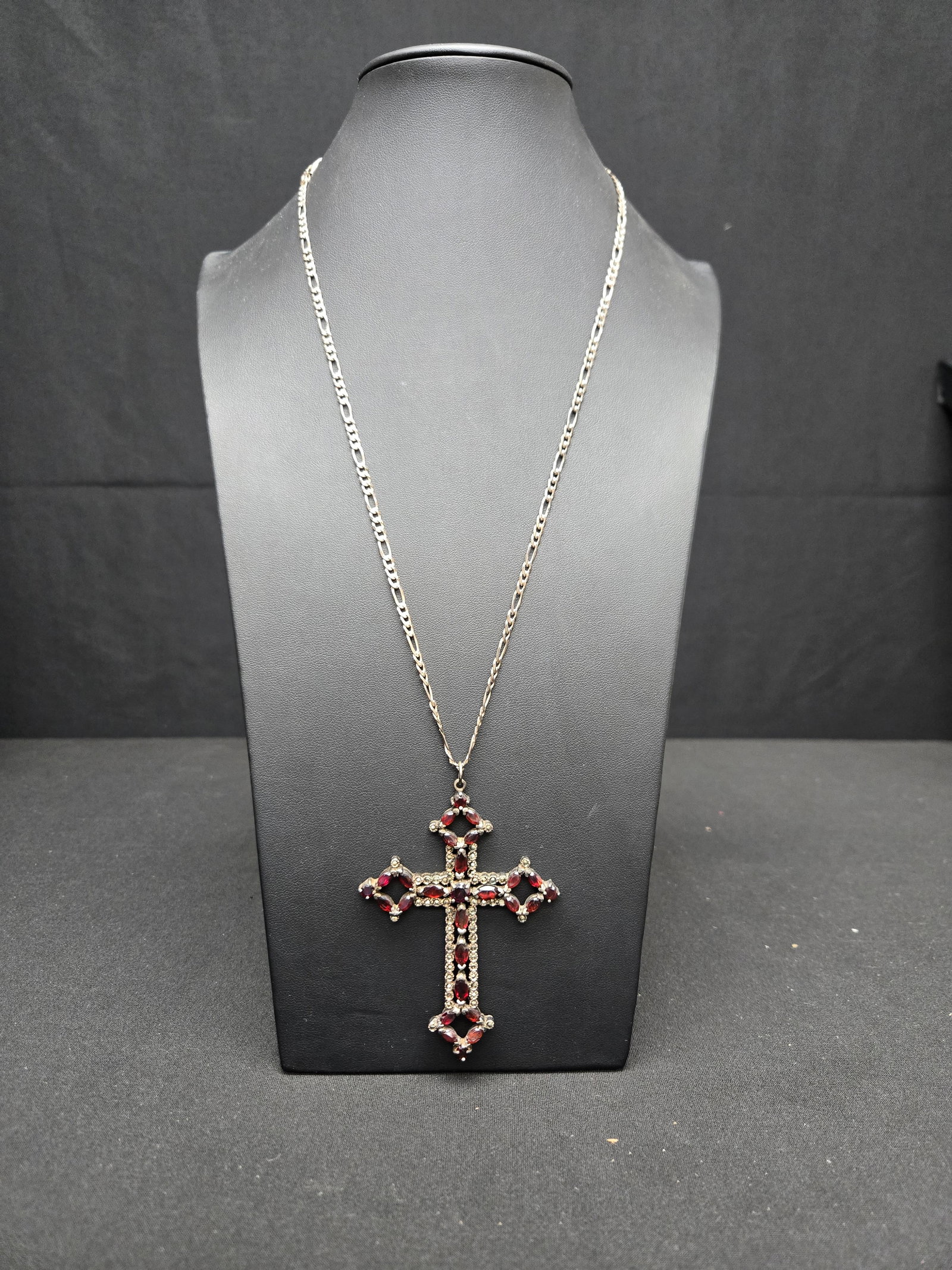 Silver (0.925) Bohemian Garnet Cross with Diamond Accent and Necklace: Silver chained necklace in the figaro belcher style with a bohemian cross pendant studded with cut and polished garnets and diamond accenting.