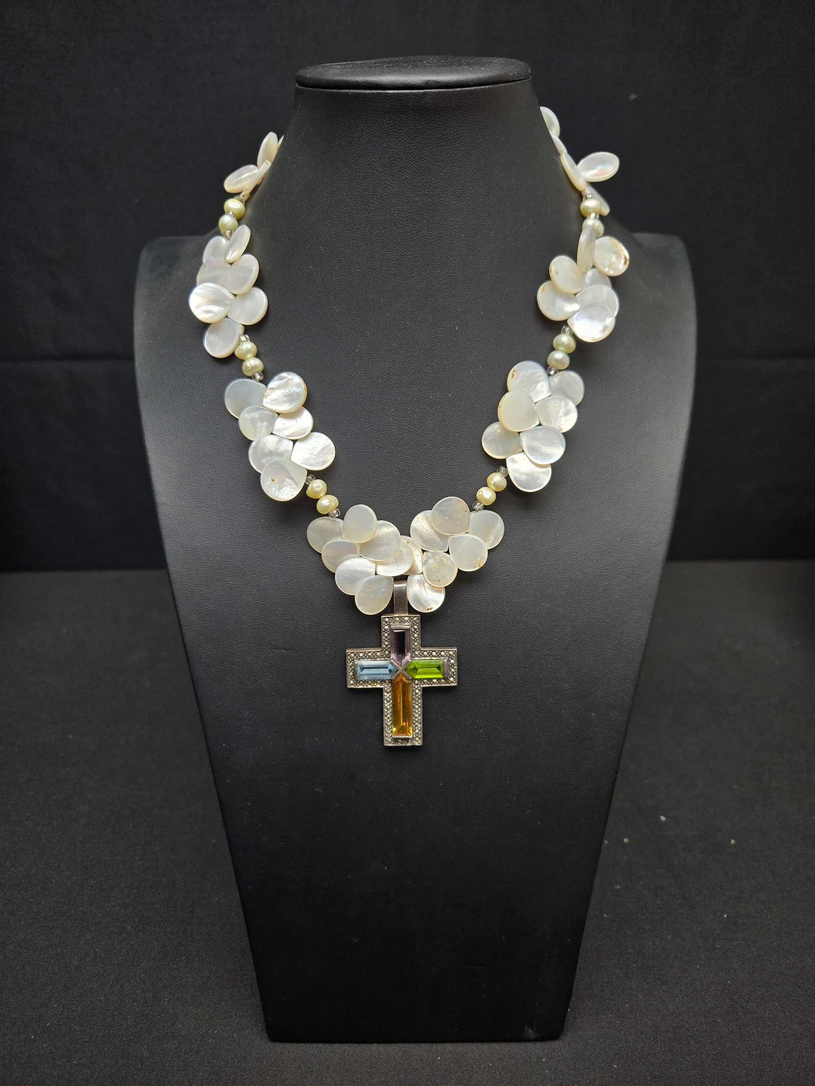 Mother of Peal Shell Necklace with Sterling Cross: Mother of pearl in bead and petal cut on a wire string with a sterling silver cross inlay with colored crystal.