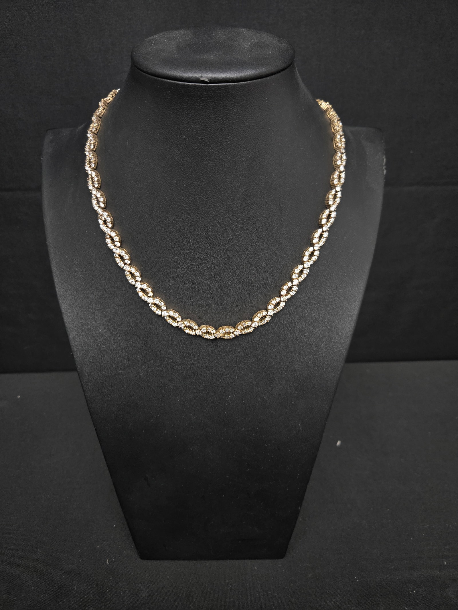 Sterling Silver Necklace Stamped PJM: Sterling silver necklace in the infinity loop style with studded white gems and a gold coloration.