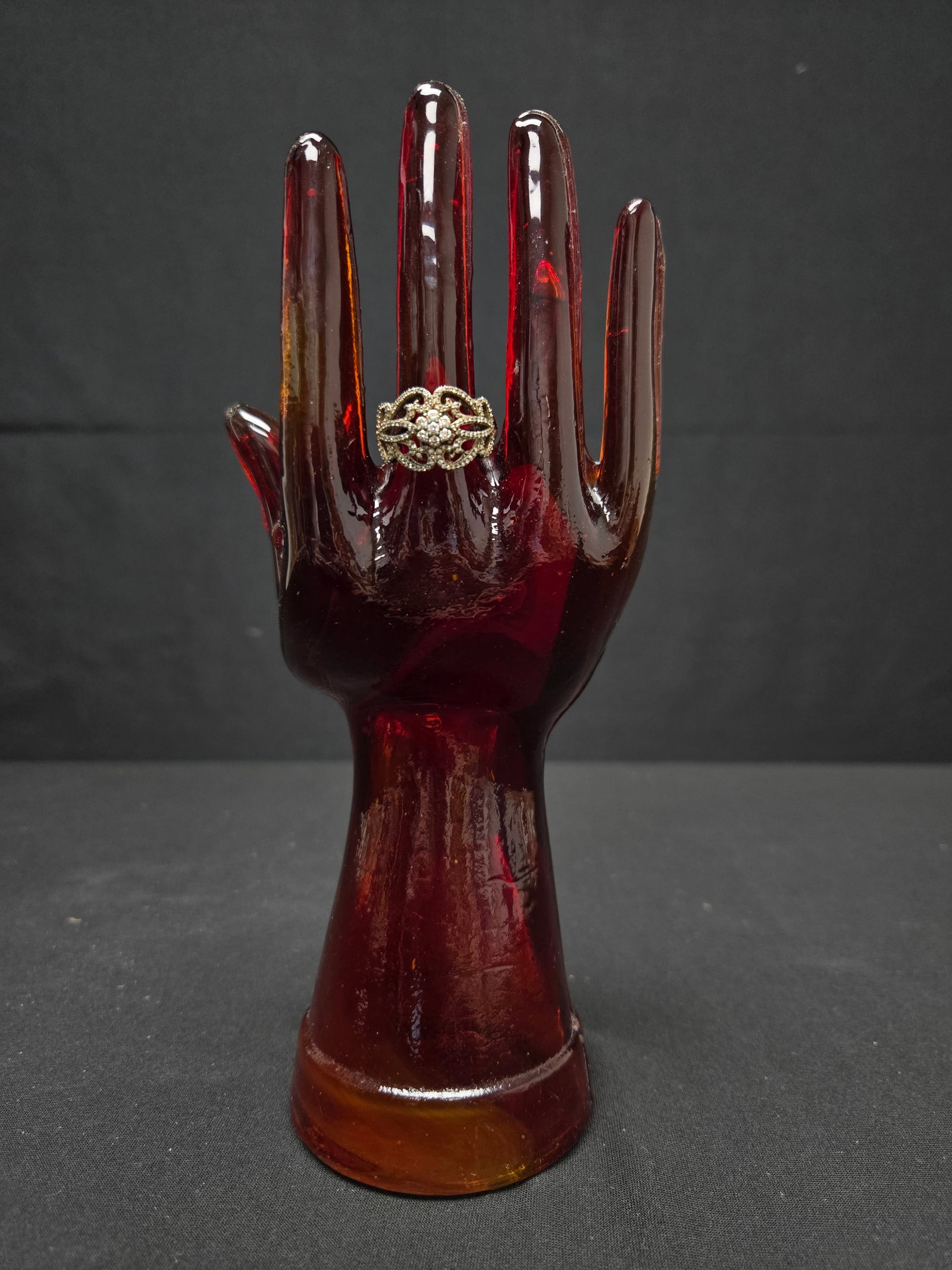 Sterling Cocktail Ring w/Embellished Filigree: Sterling cocktail style ring studded with sparkling crystal arranged in a looping floral pattern, featuring a rose design on the interior band. Ring size: 7