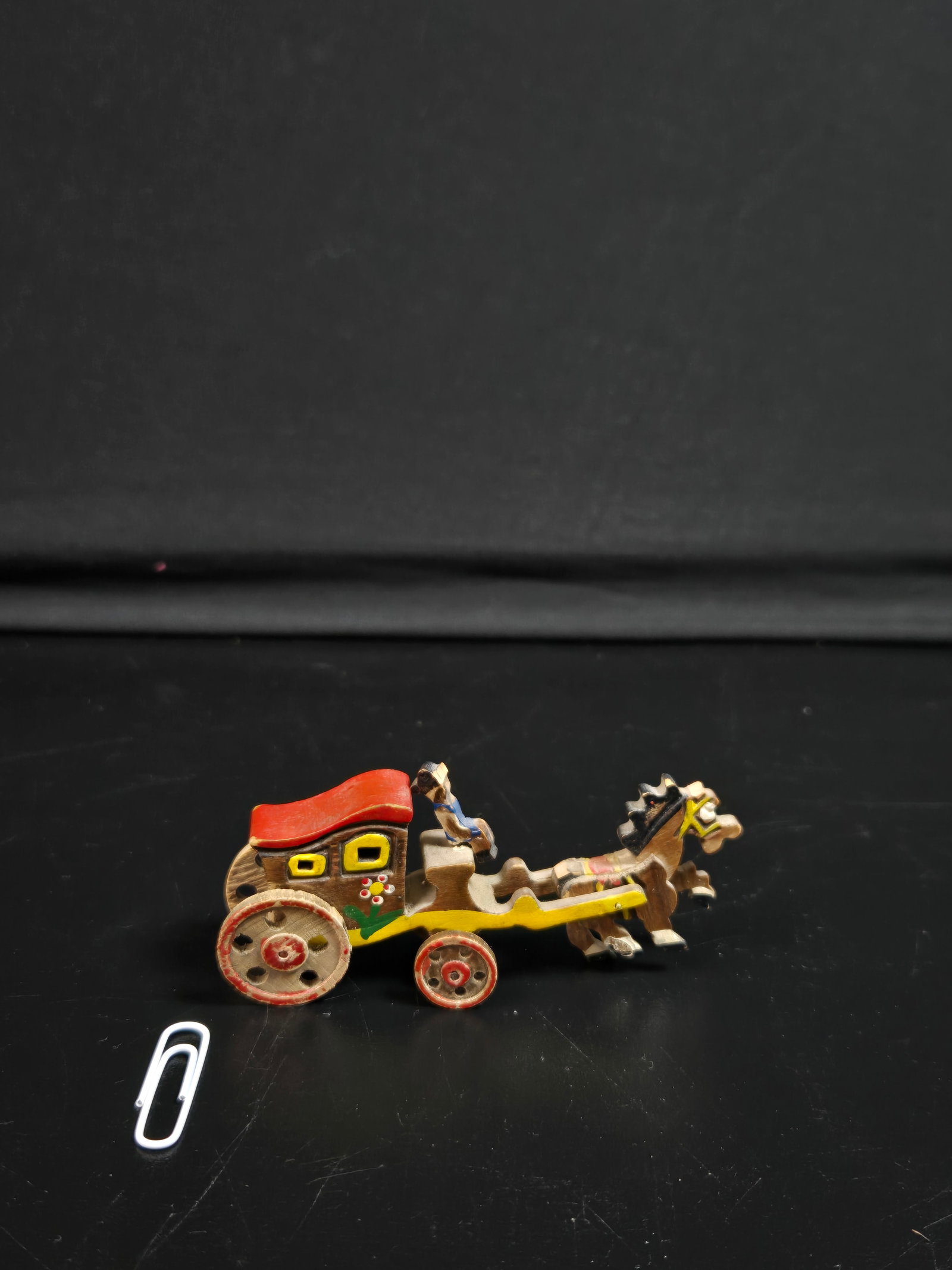 Vintage Hand Painted Miniature Horse and Cart: Vintage hand painted miniature horse and cart with driver, made in Japan as a piece of collectible folk art. Shown next to paperclip for size reference.