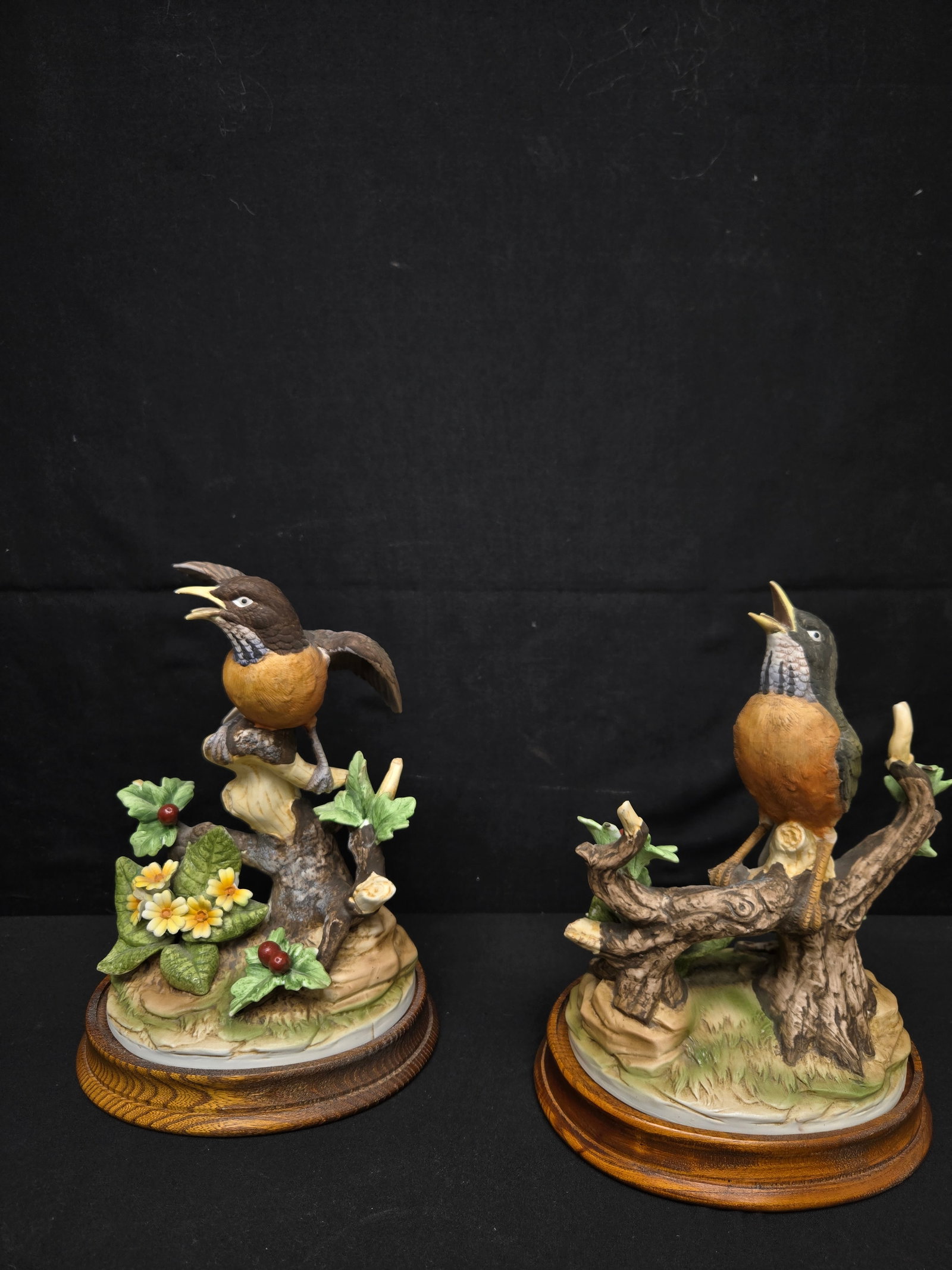 Set of Vintage Andrea Sadek Bird Statues (2pc): Set of two vintage Andrea Sadek statues. Both depict a Robin in the woods, sitting on tree stumps and surrounded by flowers. On two separate wood bases.