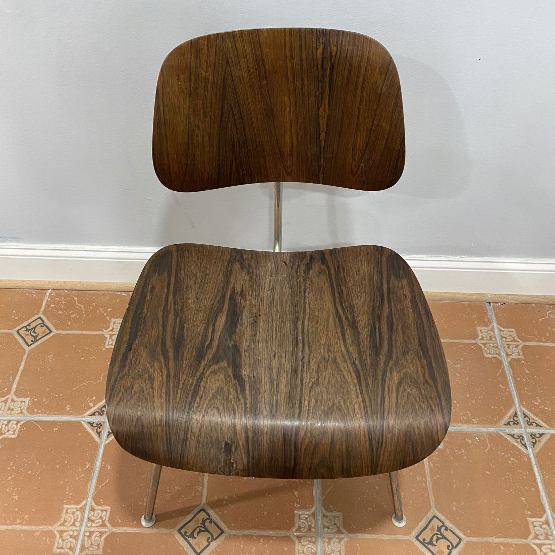 Charles Eames Herman Millers Rosewood Chair From Zeeland Michigan: This Charles Eames Herman Millers rosewood chair from Zealand Michigan is up for auction. The size is 16" floor to seat 20" wide 16" deep 30" tall back.