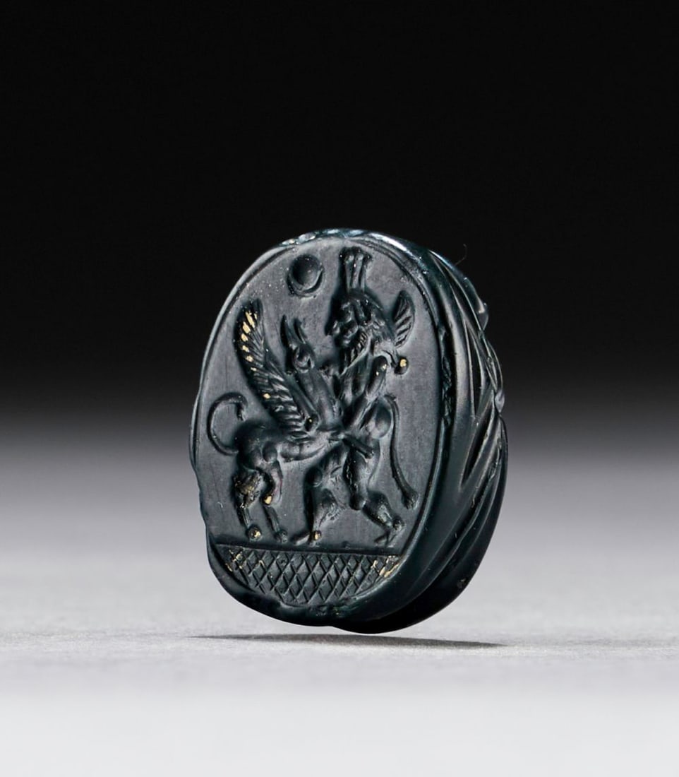 A RARE GREEN JASPER PHOENICIAN SCARAB DEPICTING A GOD FIGHTING A WINGED GRIFFIN, CIRCA 5TH CENTURY B (1 of 2)