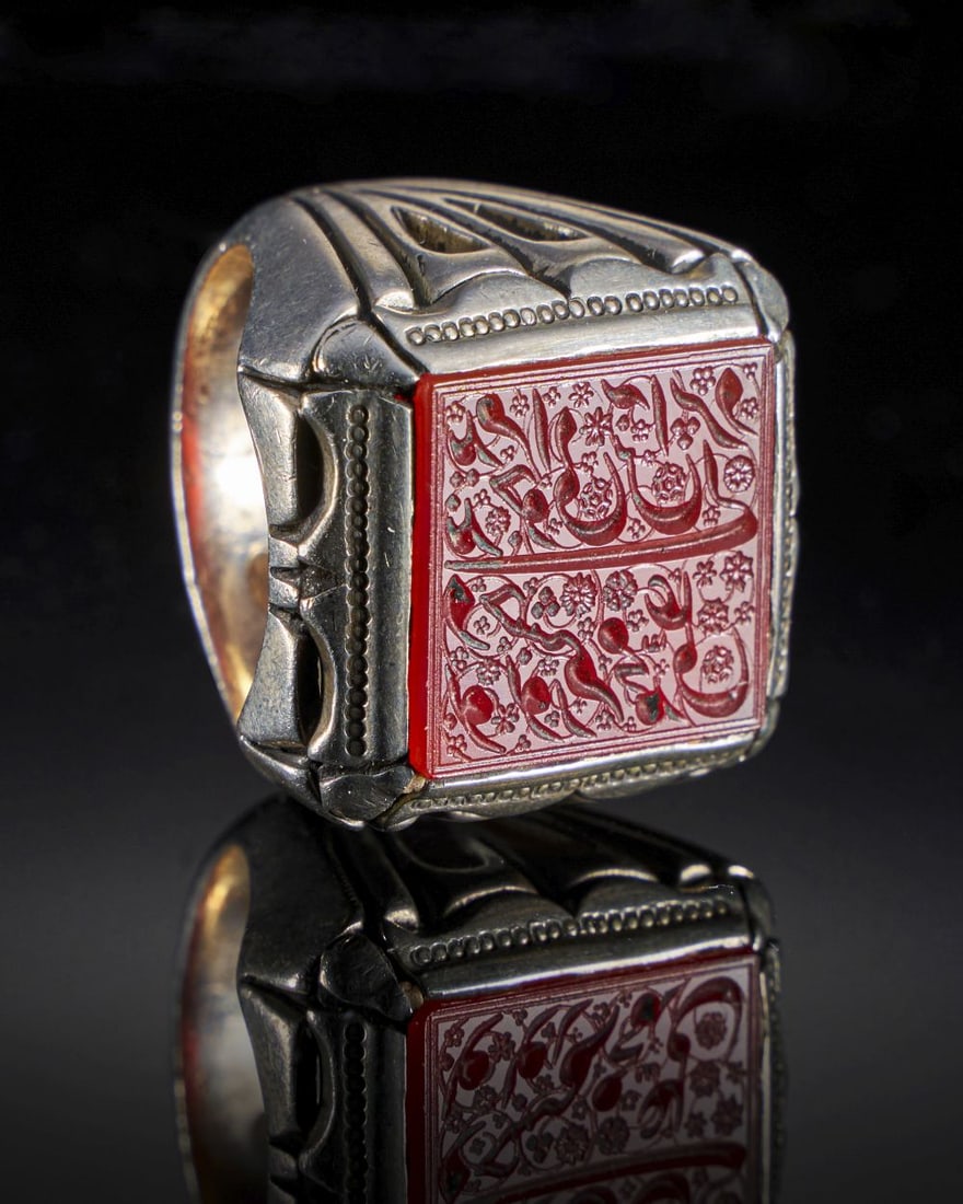A CALLIGRAPHIC INSCRIBED CARNELIAN RING ON SILVER, 19TH CENTURY, PERSIA: A CALLIGRAPHIC INSCRIBED CARNELIAN RING ON SILVER, 19TH CENTURY, PERSIA Internal Diameter: 2cm stone 2.2cm x 2cm