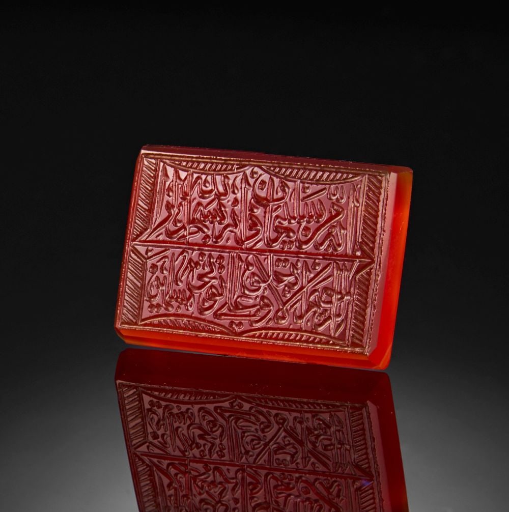 A CALLIGRAPHIC INSCRIBED AGATE TABLET, 19TH CENTURY, PERSIA: A CALLIGRAPHIC INSCRIBED AGATE TABLET, 19TH CENTURY, PERSIA Length x Width: 2.2 x 1.6cm