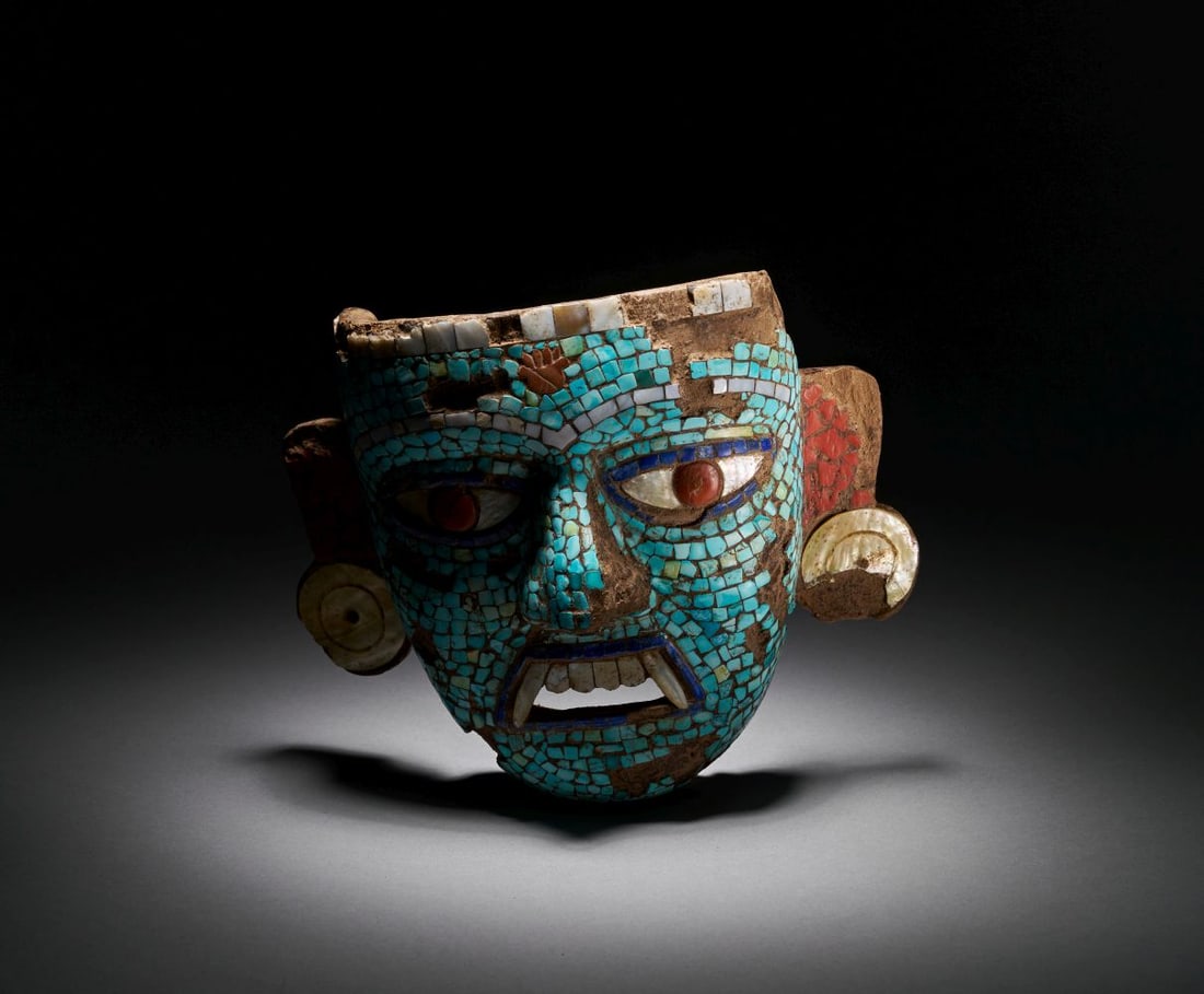 A WOODEN GEM INLAID ORNAMENTAL MASK, CIRCA 6TH-7TH CENTURY, PERU: A WOODEN GEM INLAID ORNAMENTAL MASK, CIRCA 6TH-7TH CENTURY, PERU A superb ceremonial mask of carved wood, richly inlaid with turquoise, shell, spondylus, and mother-of-pearl tesserae, forming a strik