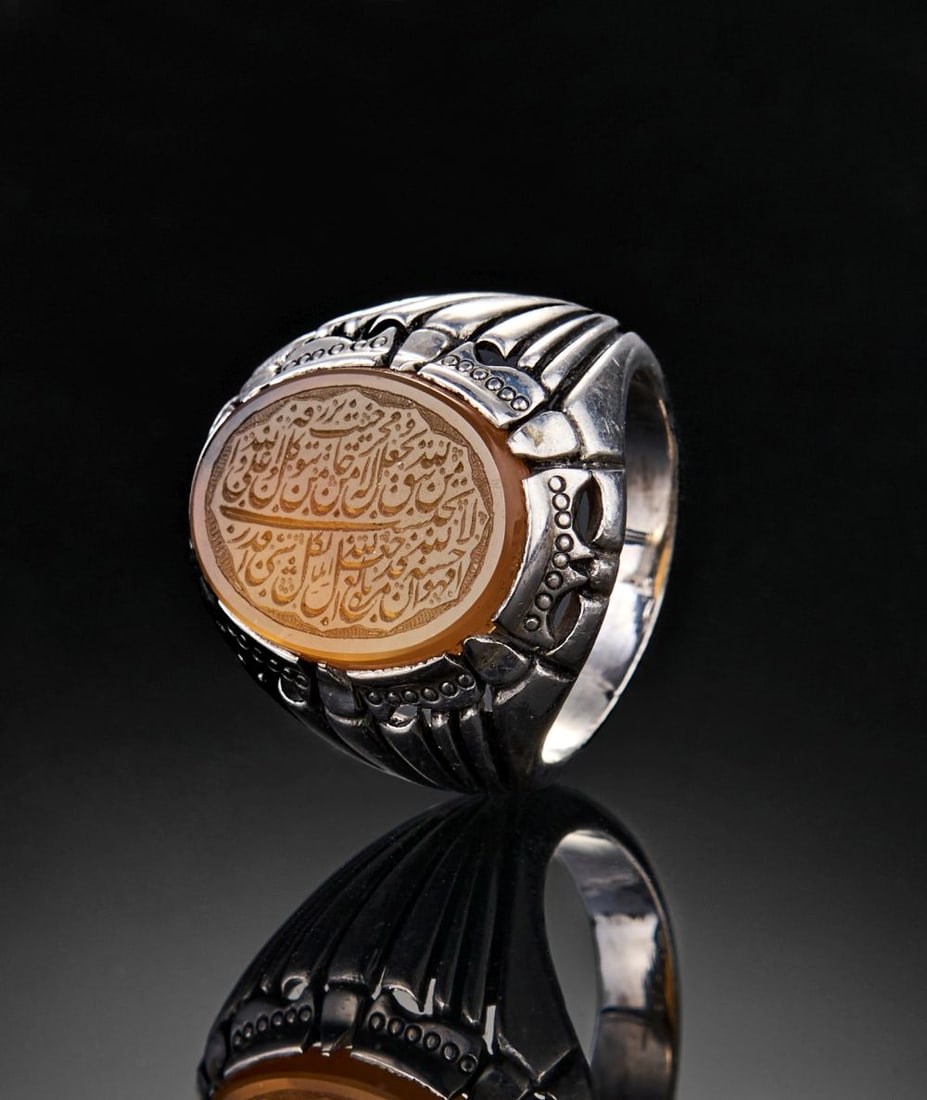 A CALLIGRAPHIC INSCRIBED CARNELIAN RING, 19TH CENTURY, PERSIA: Lot 144. A CALLIGRAPHIC INSCRIBED CARNELIAN RING, 19TH CENTURY, PERSIA This fine calligraphic ring from 19th-century Persia is set with an oval carnelian (aqeeq) stone finely engrave