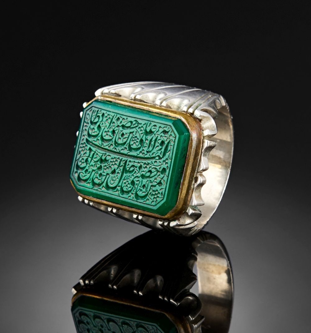 A CALLIGRAPHIC INSCRIBED BERYL RING, 19TH CENTURY, PERSIA: Lot 150. A CALLIGRAPHIC INSCRIBED BERYL RING, 19TH CENTURY, PERSIA This distinguished Persian ring from the 19th century showcases a rectangular green beryl bezel finely engraved wit