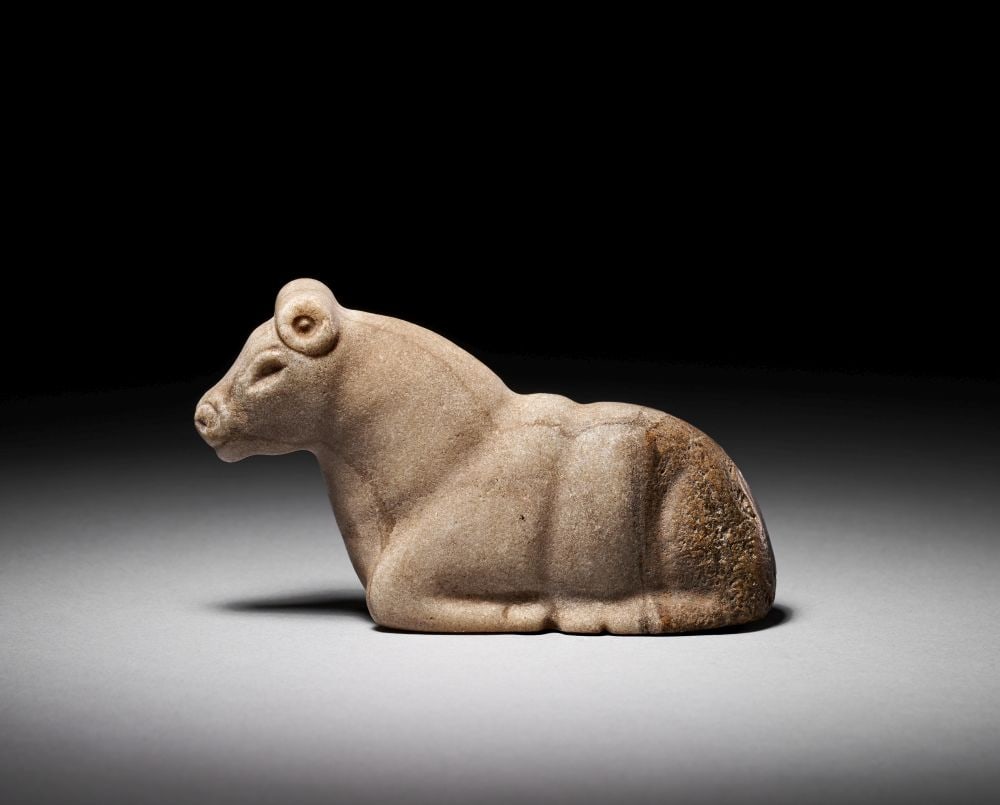 A MESOPOTAMIAN WHITE STONE SEATED COW, CIRCA 3300-2900 B.C. (1 of 5)