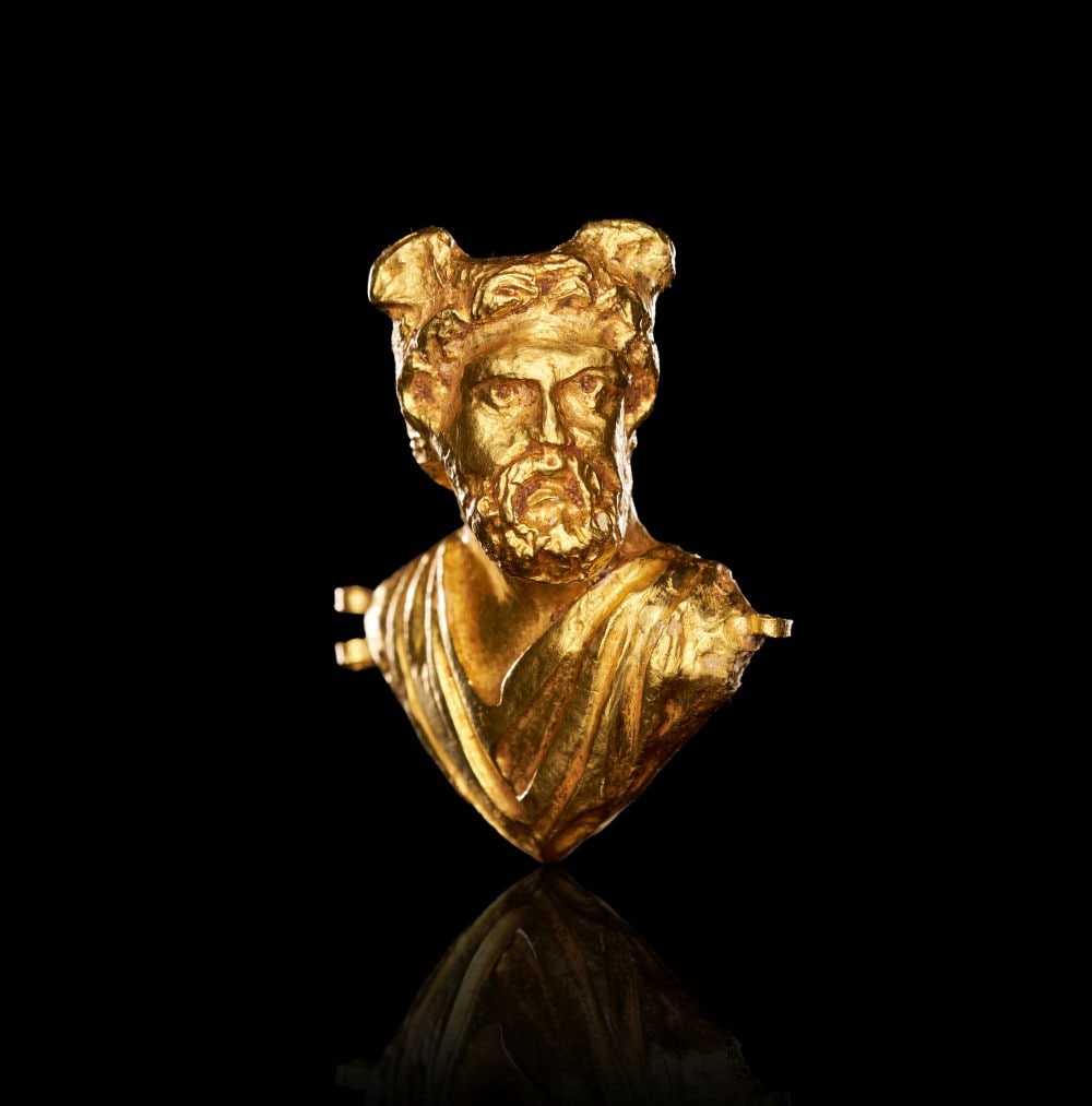A ROMAN REPOUSSÉ GOLD BUST OF A GOD WITH WINGED HEAD, POSSIBLY HERMES, CIRCA 2ND CENTURY A.D. (1 of 3)