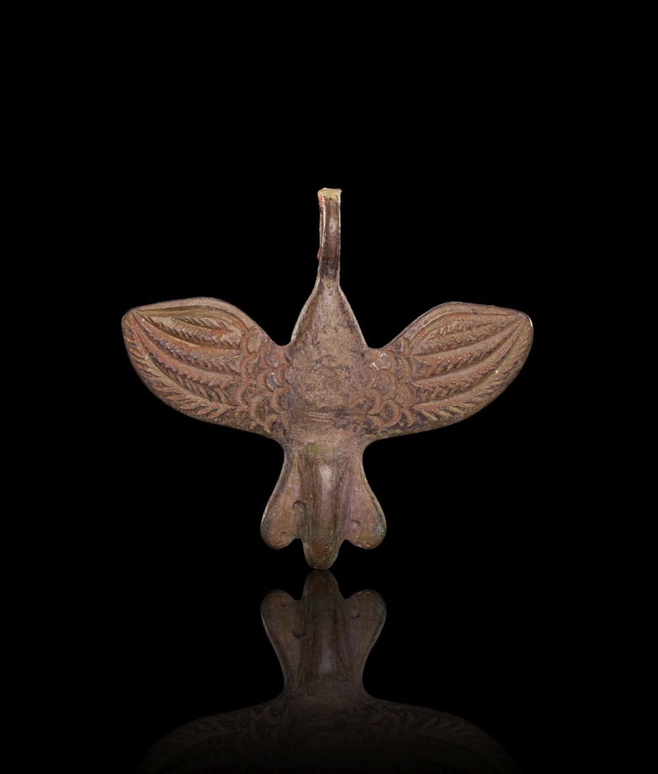 A NEO-BABYLONIAN SILVER AMULET IN THE FORM OF A BIRD CIRCA 8TH-7TH CENTURY B.C. (1 of 2)