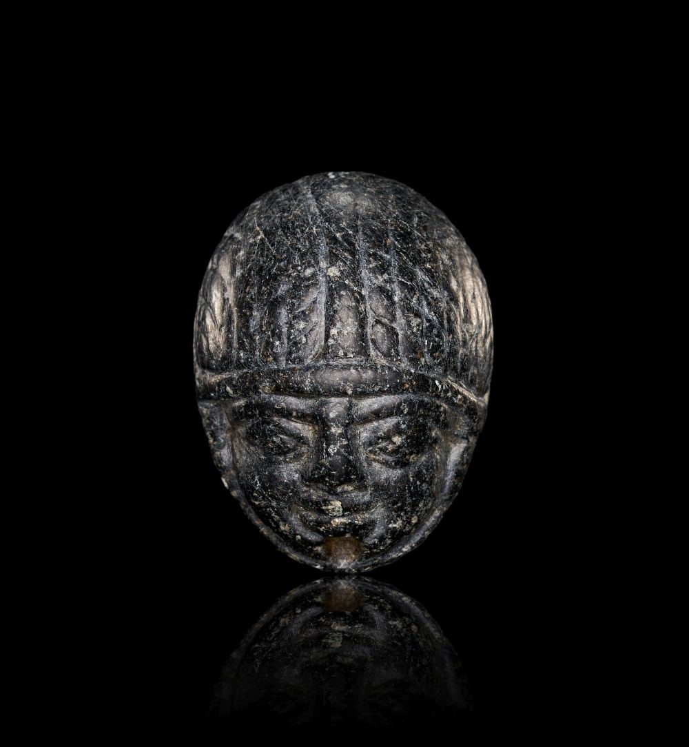 AN EGYPTIAN BLACK STONE HEART SCARAB LATE NEW KINGDOM, CIRCA 900 B.C. (1 of 3)