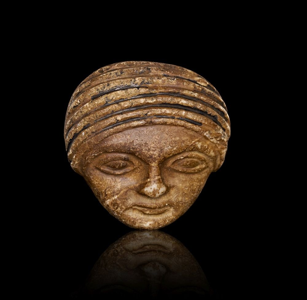 A WESTERN ASIATIC HARDSTONE HEAD OF A WORSHIPPER, CIRCA LATE 3RD-EARLY 2ND MILLENNIUM B.C (1 of 3)